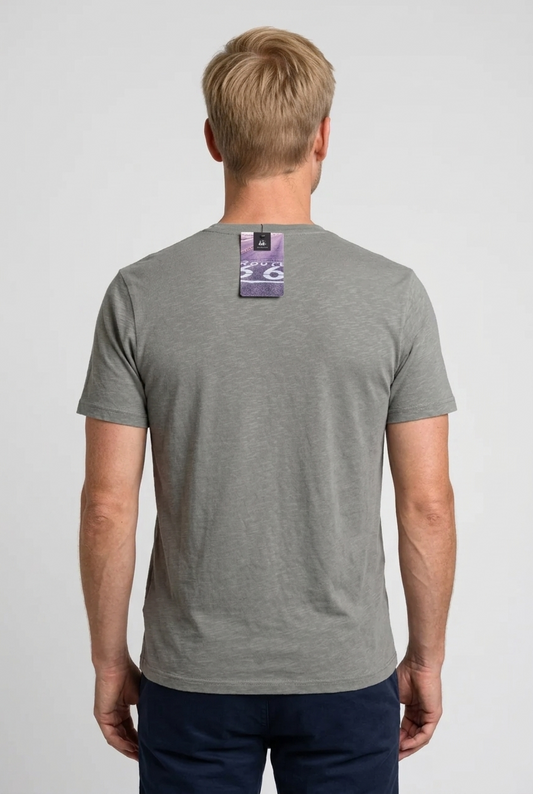 Man wearing a gray t-shirt with a brand label on the back