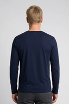 Man wearing a navy long-sleeve shirt 