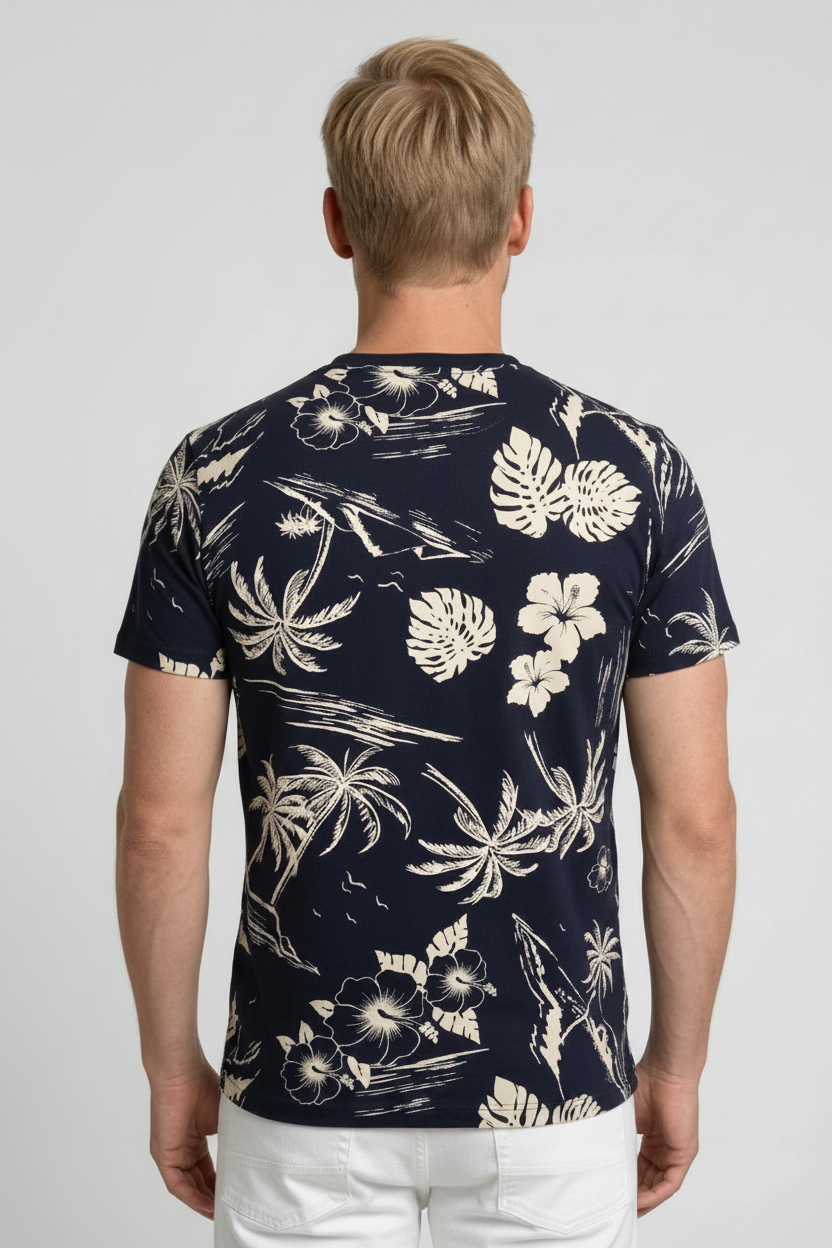 Man wearing a navy blue t-shirt with white floral and palm tree pattern 