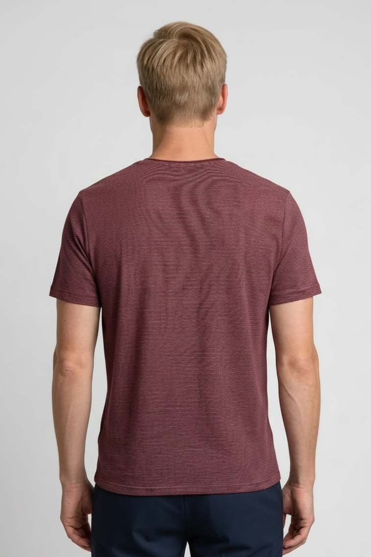 Man wearing a maroon t-shirt with a subtle pattern 