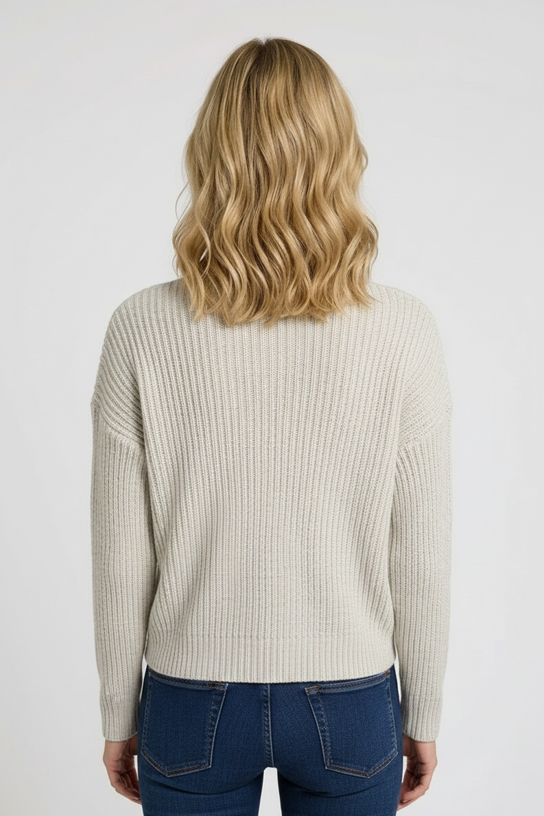 Person wearing a beige ribbed sweater back view