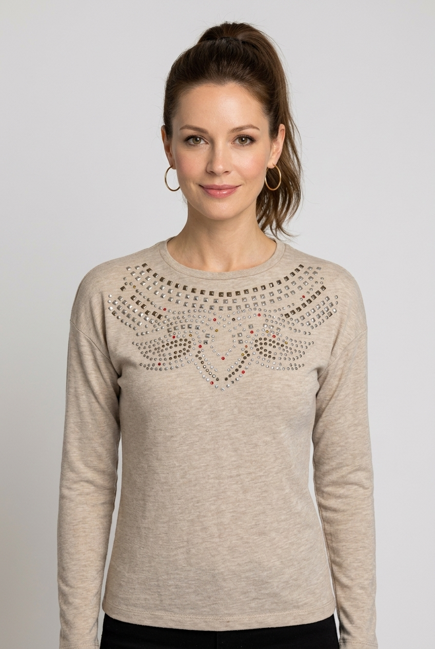 Woman wearing a beige sweater with decorative neckline