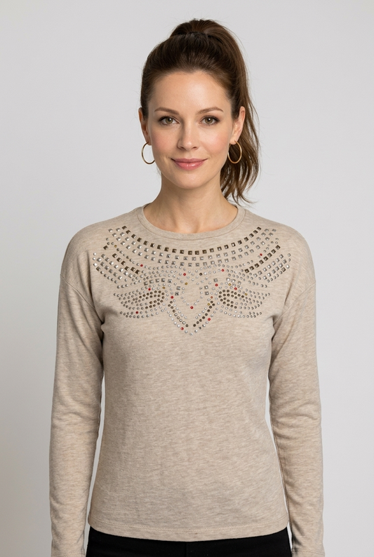 Woman wearing a beige sweater with decorative neckline