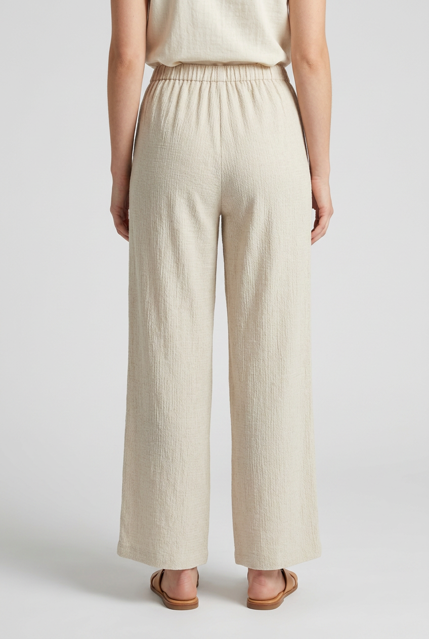 Woman wearing beige wide-leg trousers