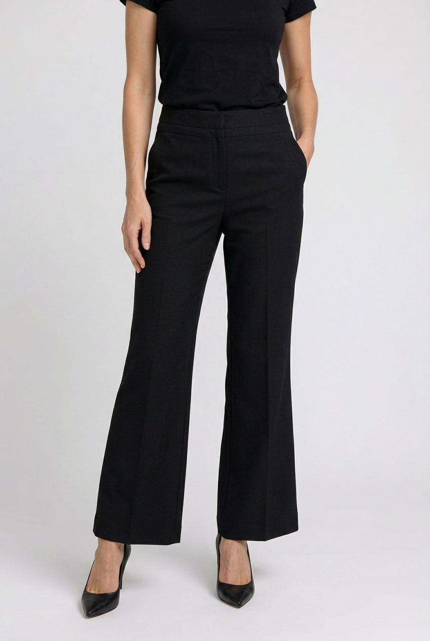 Woman wearing black flared trousers and a black top 