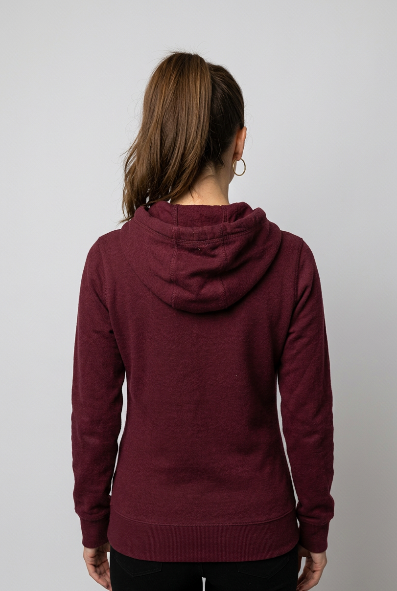 Woman wearing a maroon hoodie from behind on a plain background