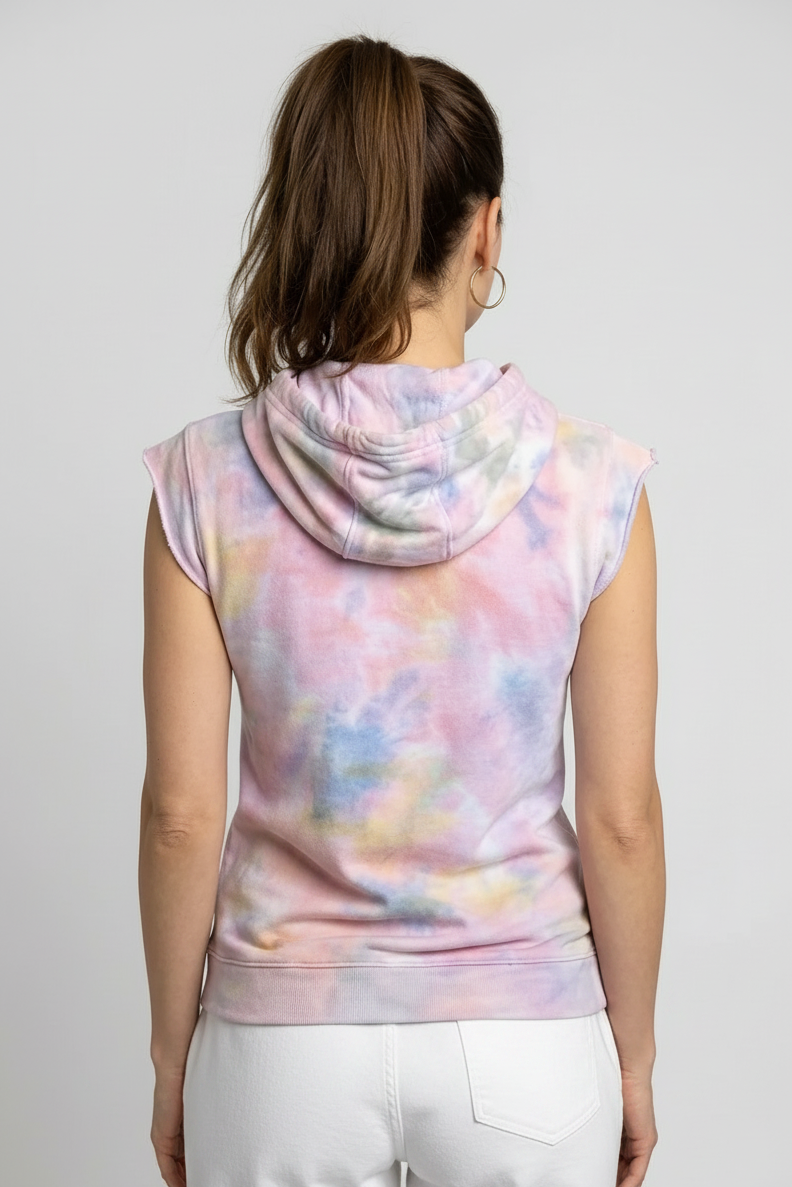 Woman wearing a sleeveless tie-dye hoodie with pastel colors on a plain background