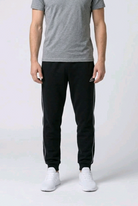 Close up of a man wearing a pair of Adidas joggers size XL front view