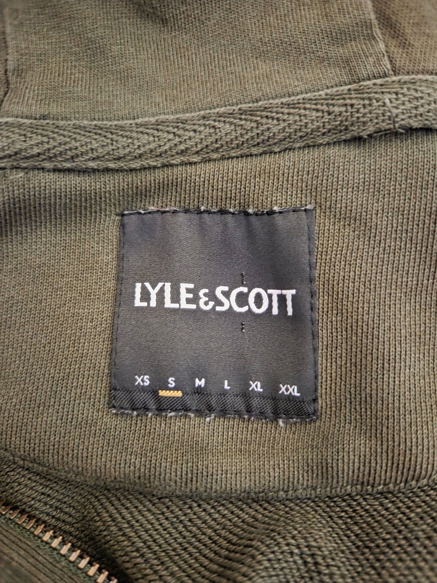 Close-up of hoodie label showing size and brand details