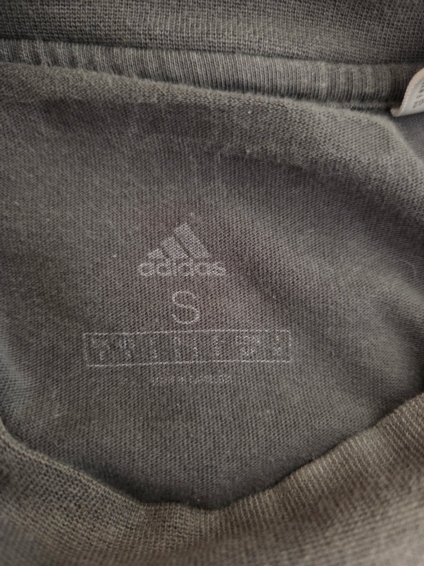Size written on a grey t-shirt