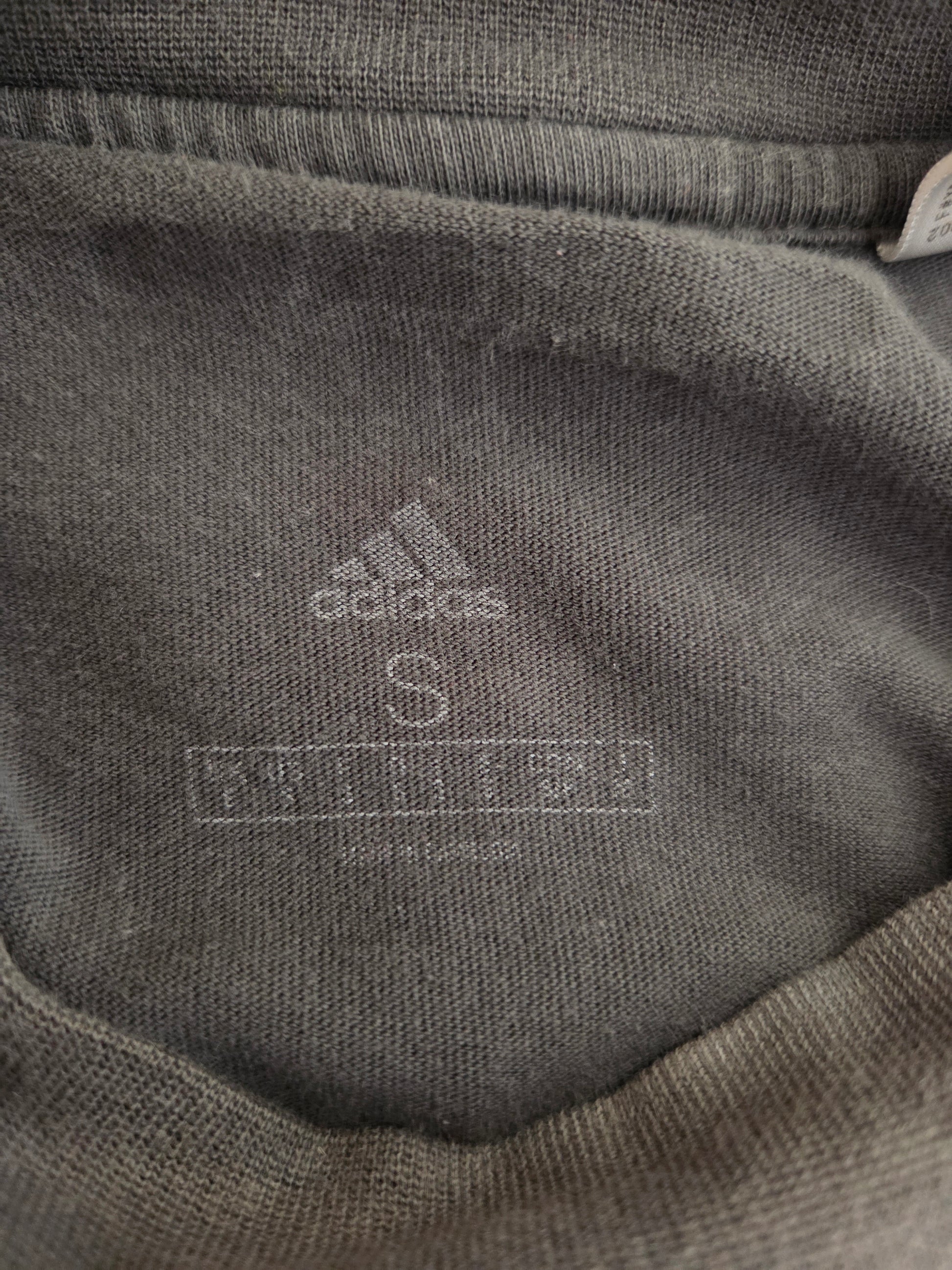 Size written on a grey t-shirt
