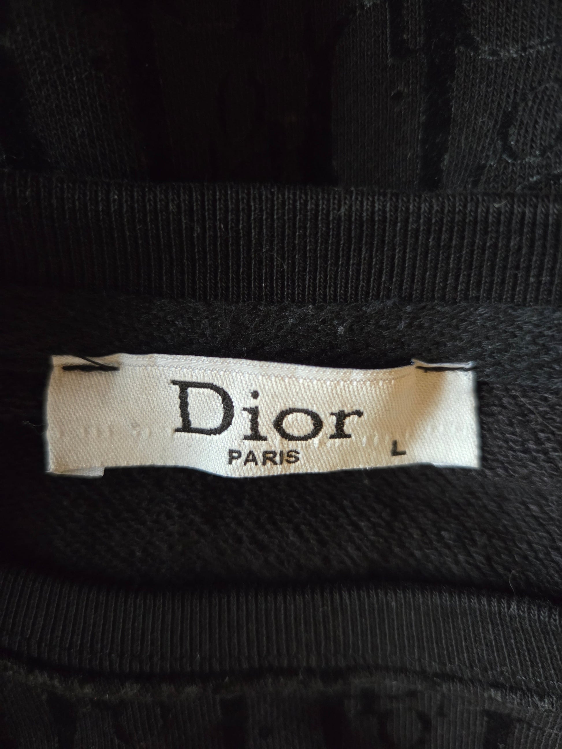 Close-up of a Dior label on black fabric
