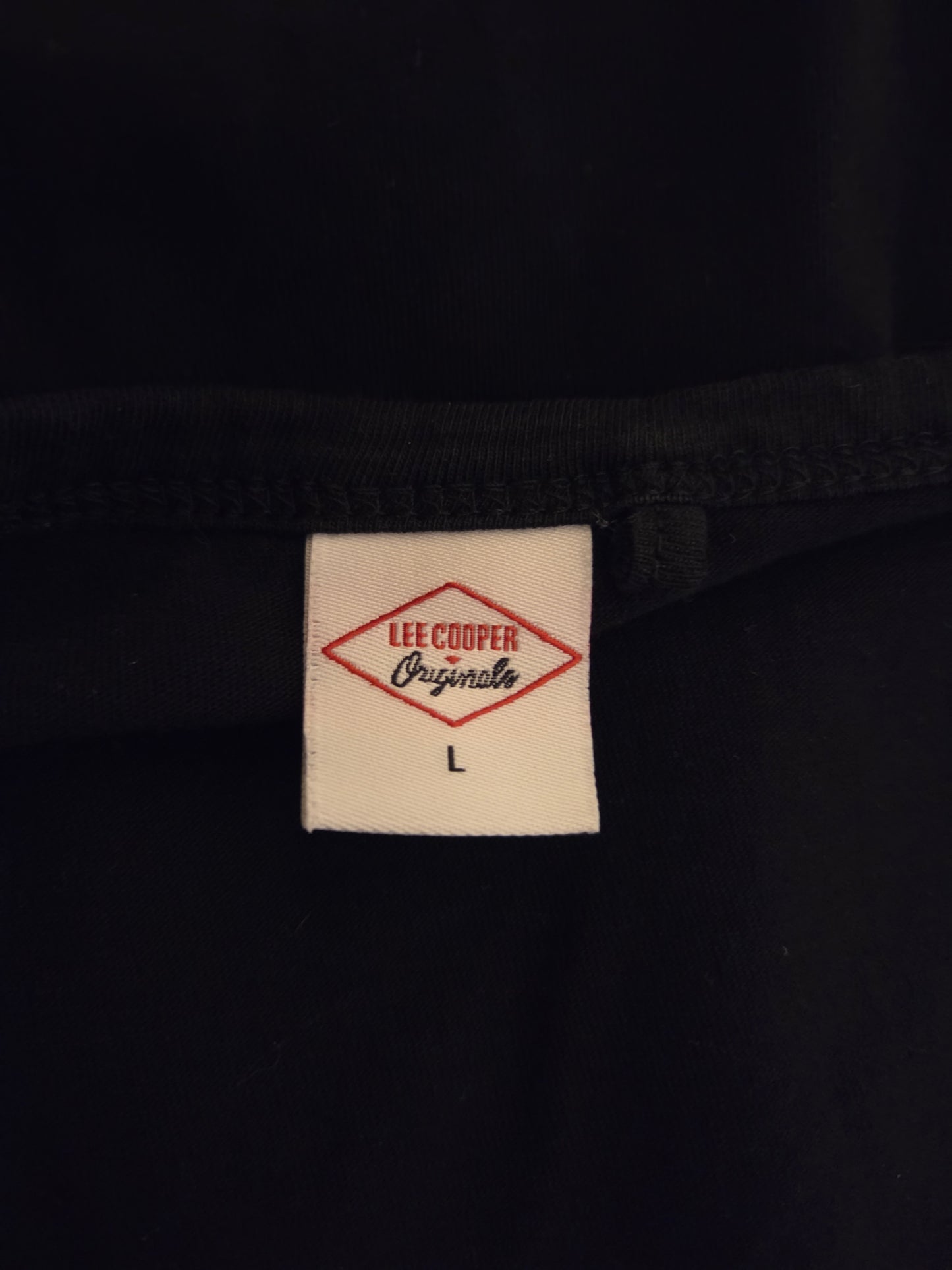 Close-up of a Lee Cooper size label on a black garment