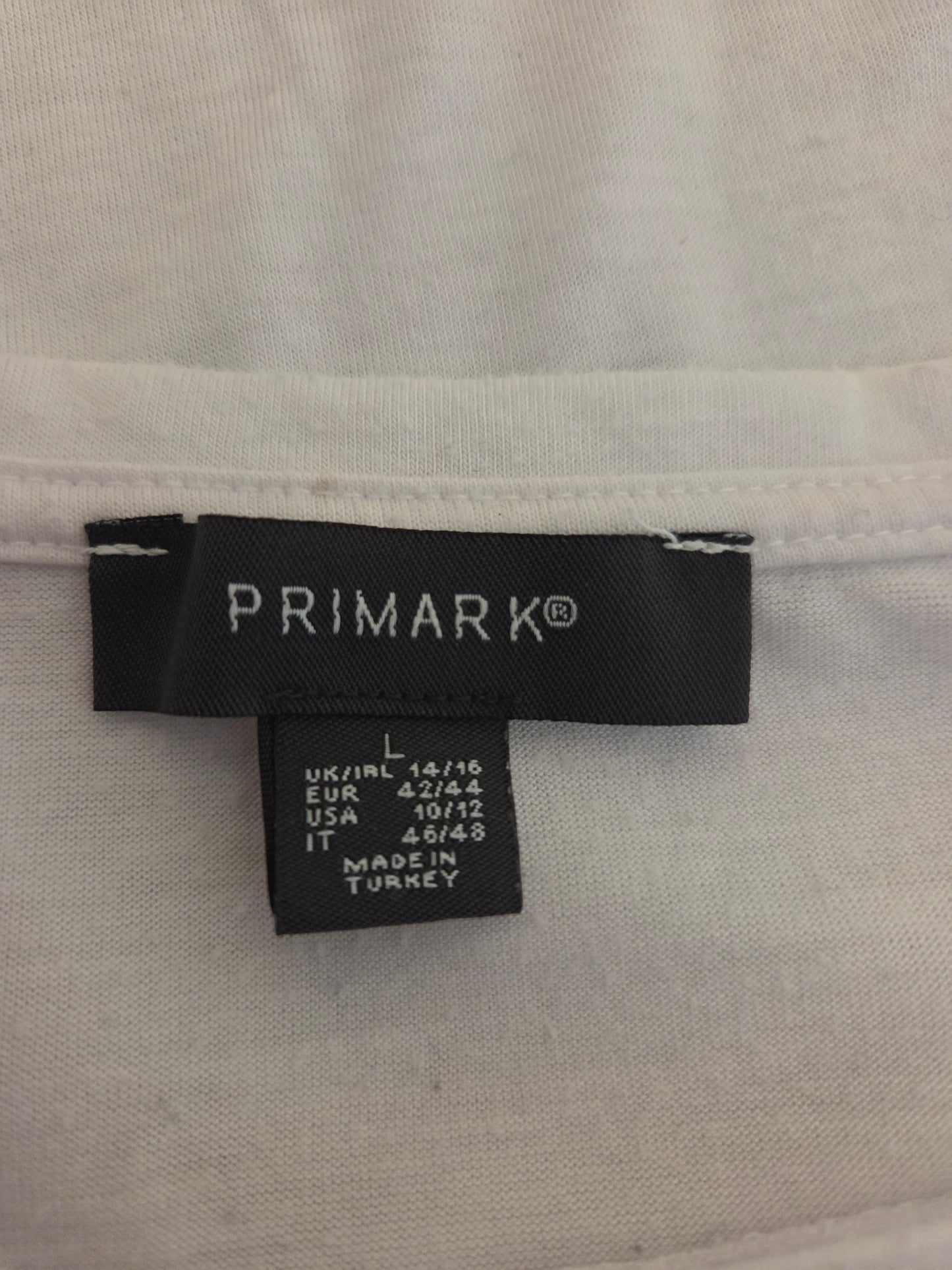 Primark label on a white shirt with size information