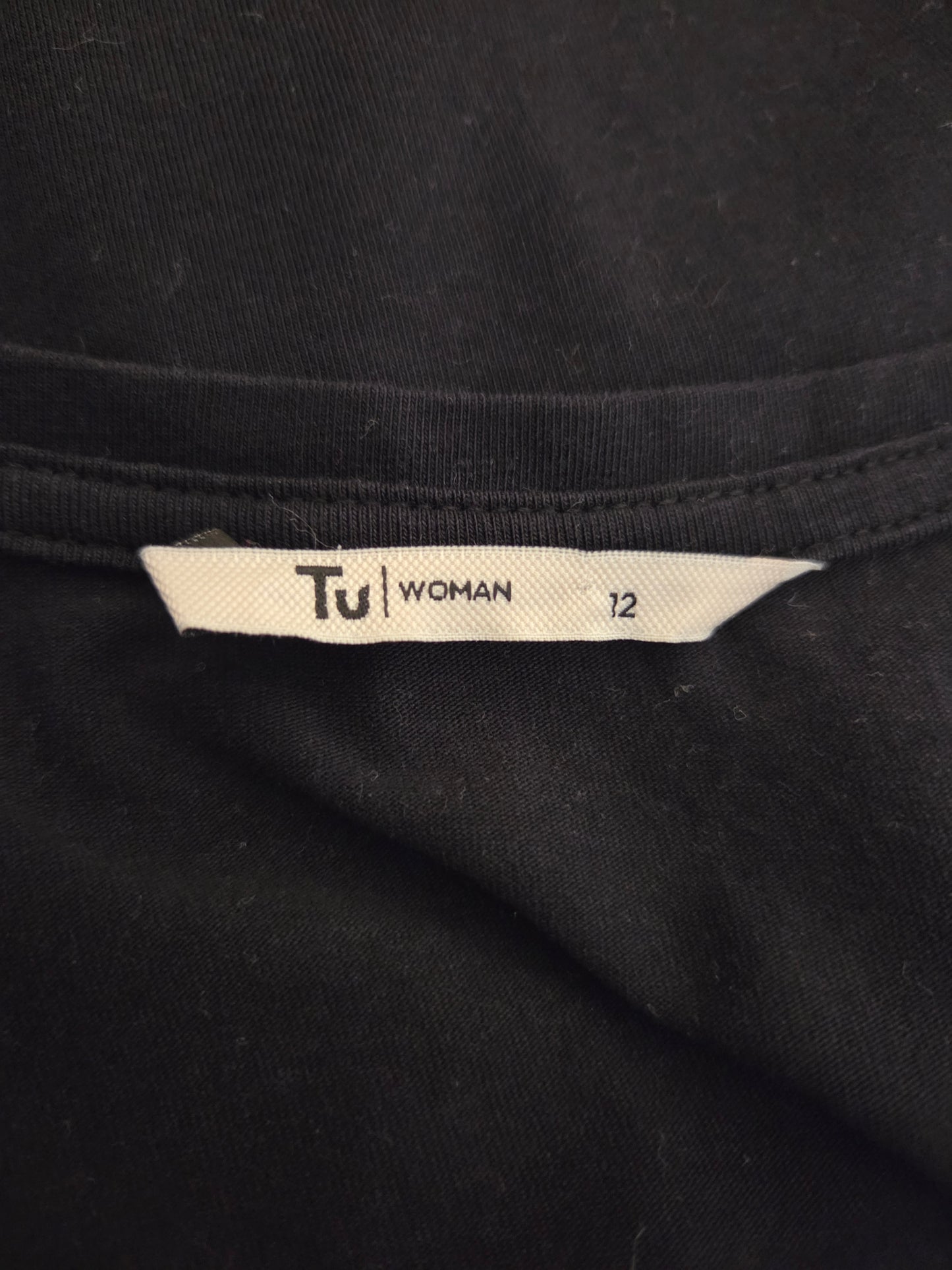Black fabric with a 'Tu Woman' size label 
