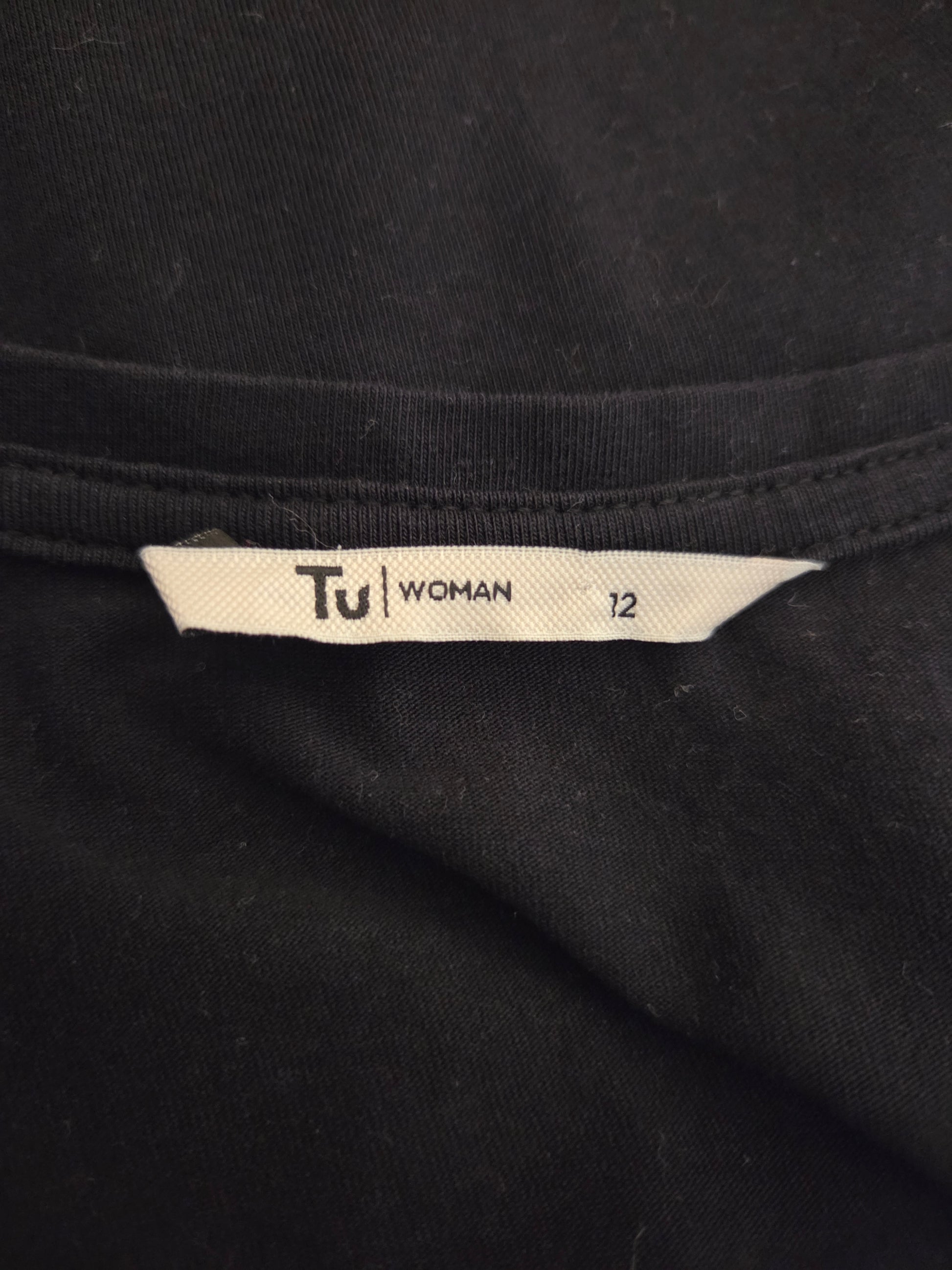 Black fabric with a 'Tu Woman' size label 