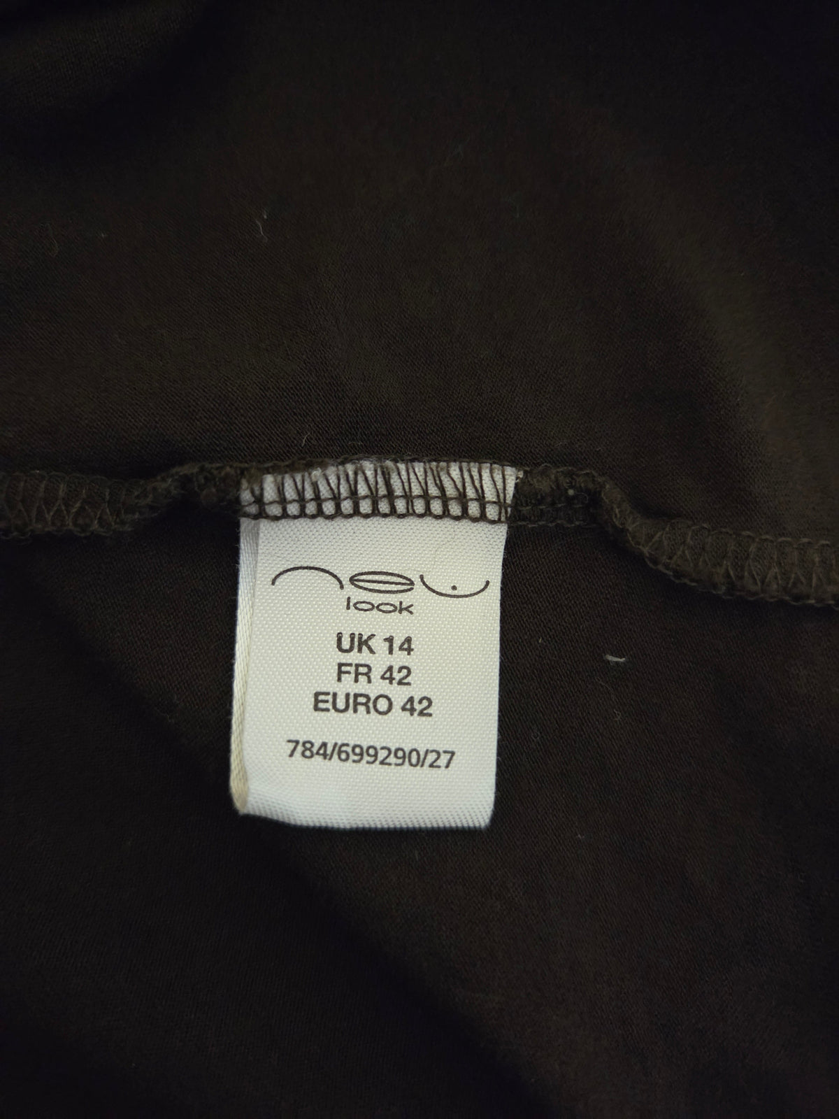 Clothing tag on a dark fabric background