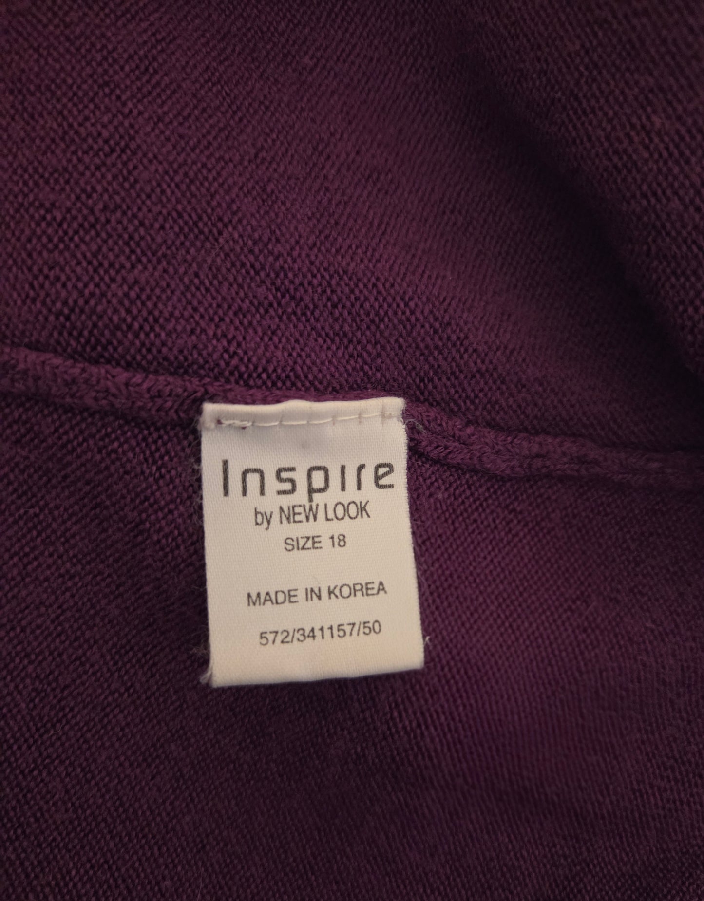 Size label on a purple garment with 'Inspire by New Look' branding.