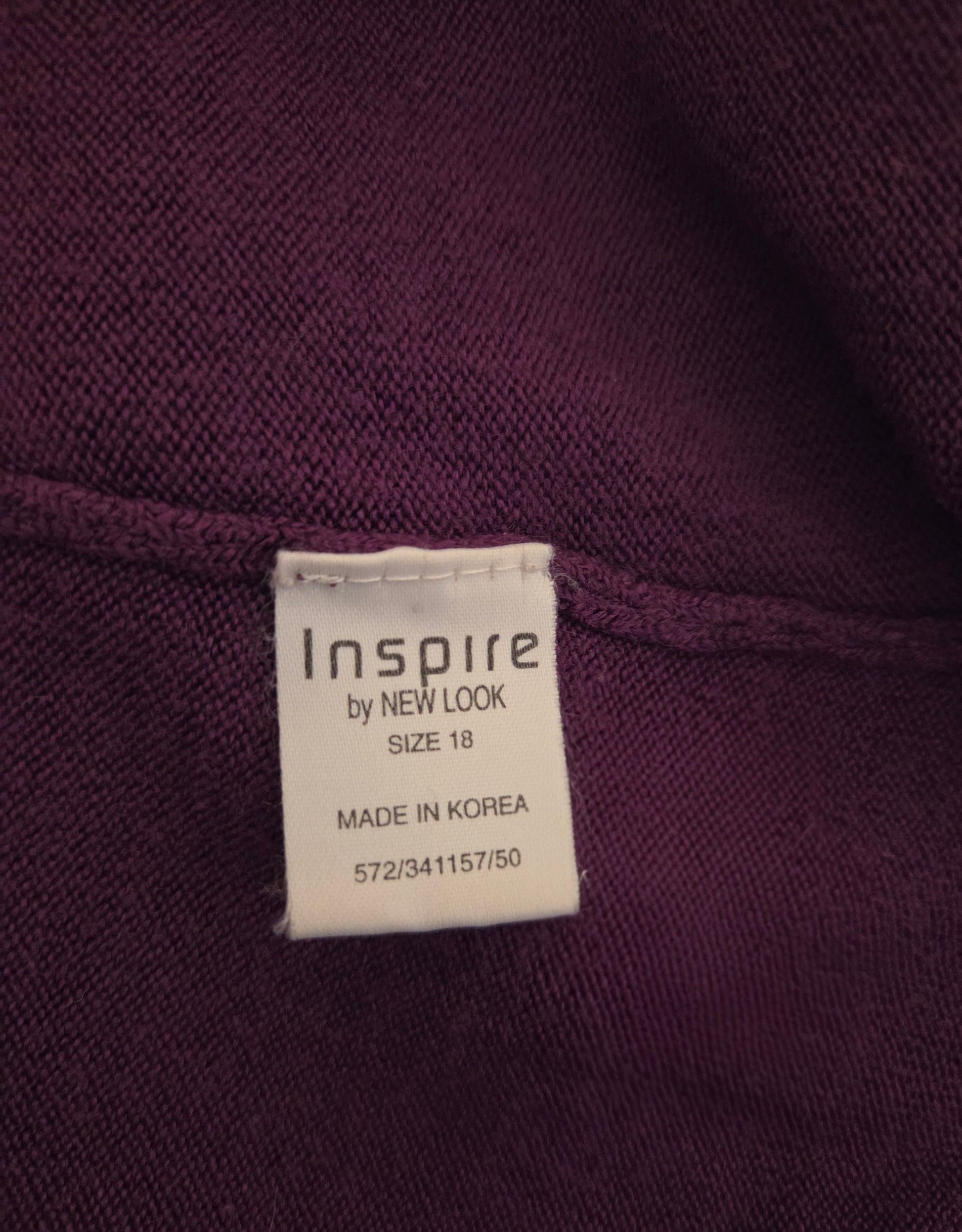 Size label on a purple garment with 'Inspire by New Look' branding.