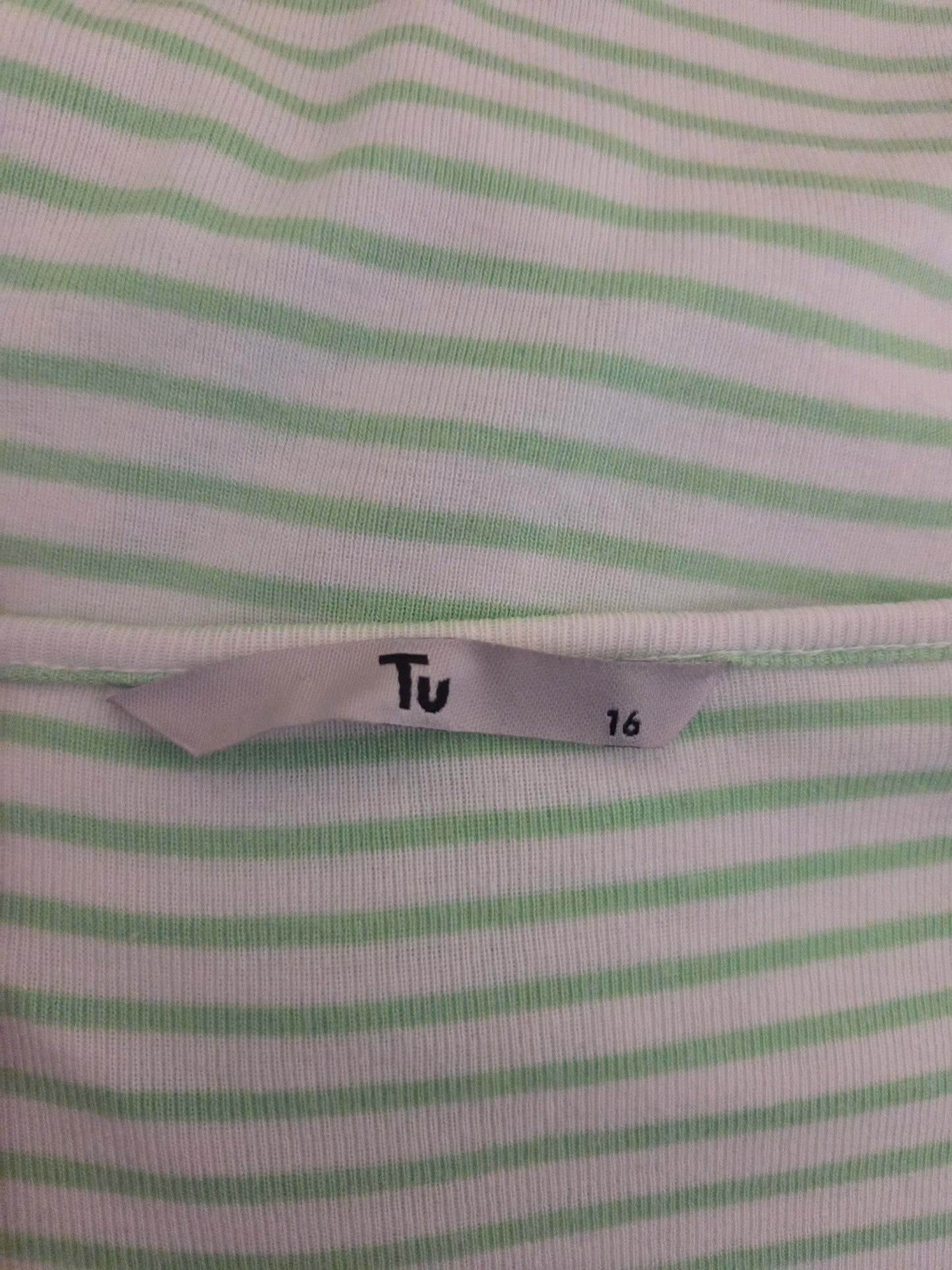 Close-up of a fabric with green stripes and a size label