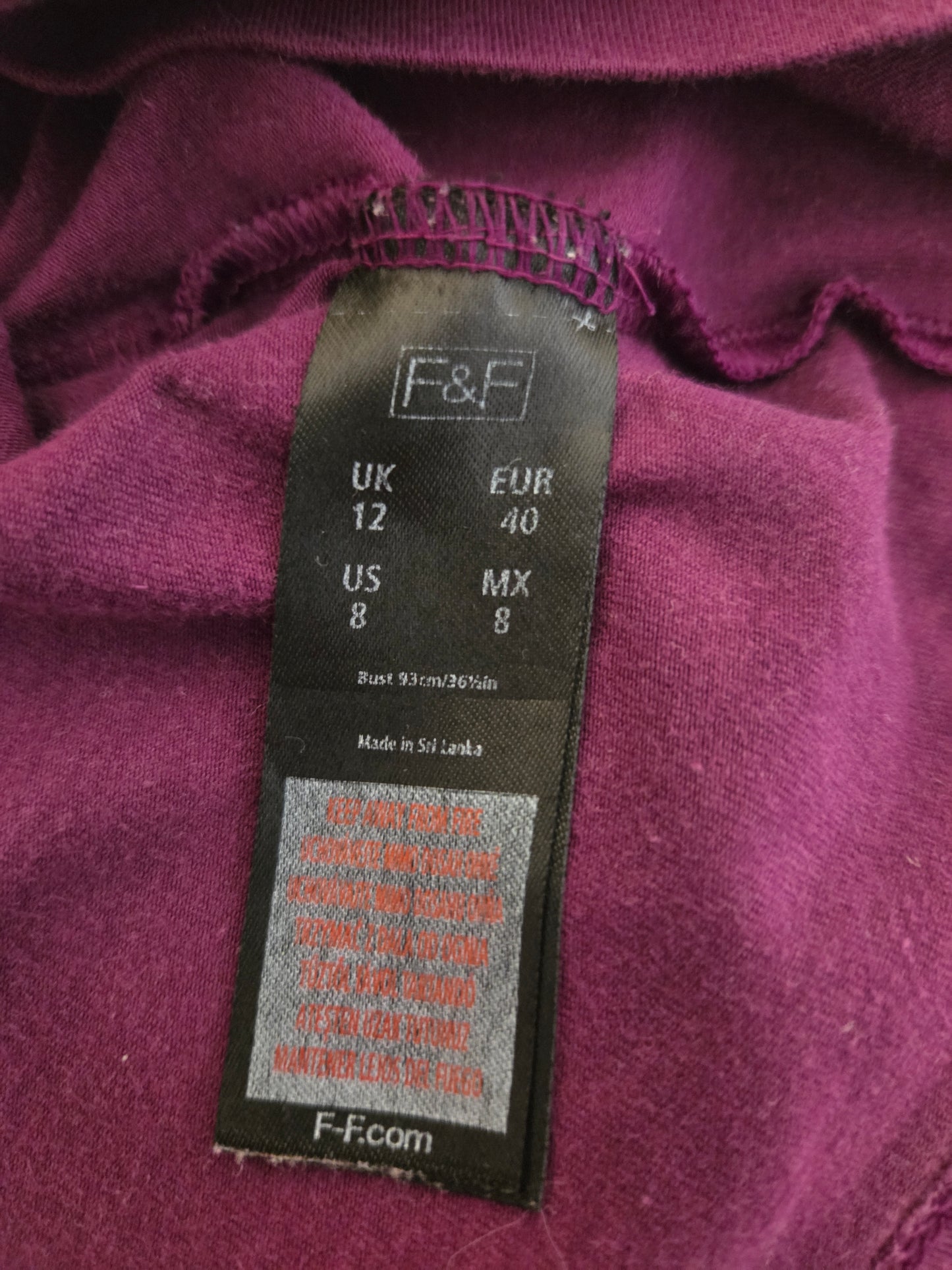 Close-up of a purple garment with a size label 