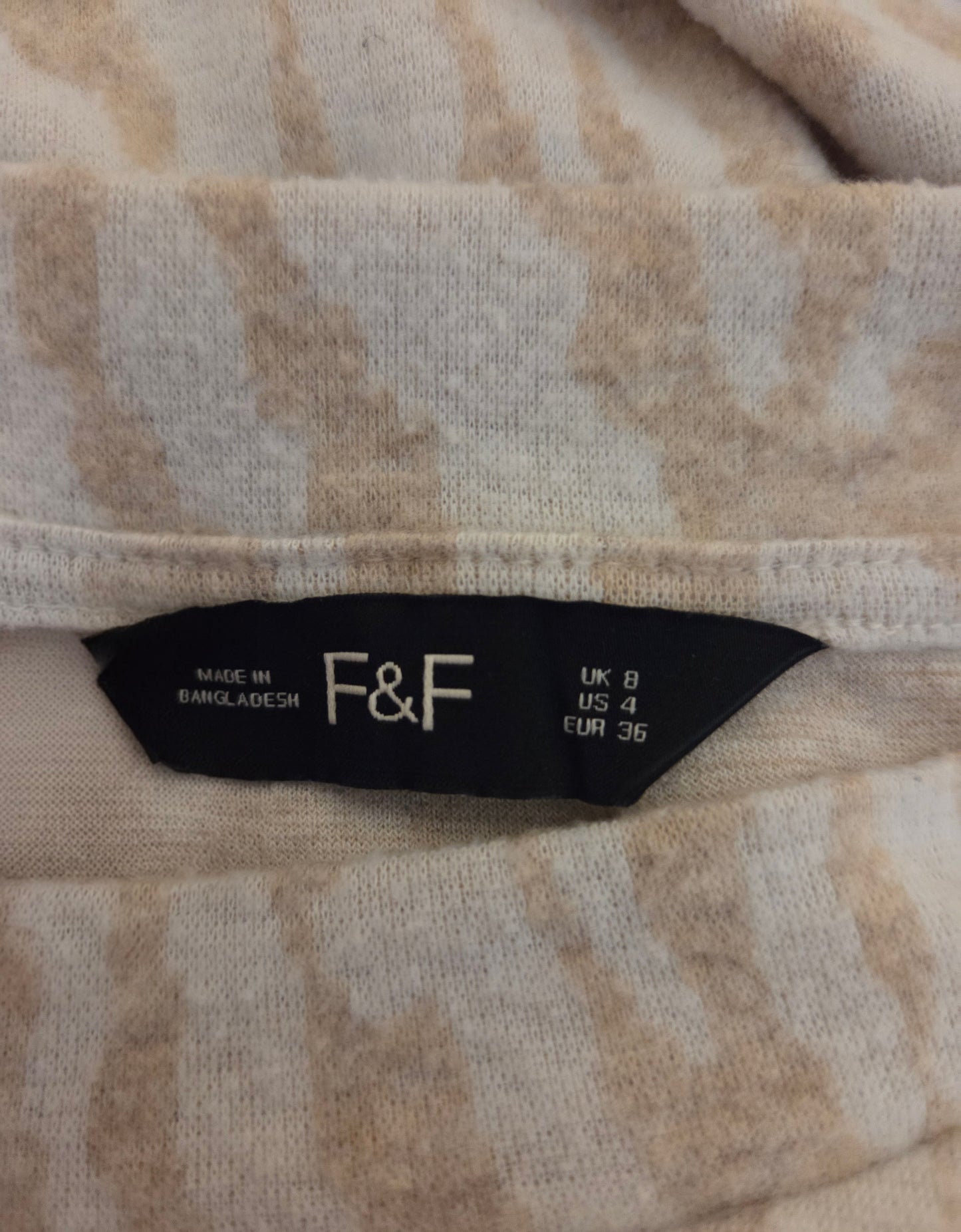 Close-up of a size label with 'F&F' 