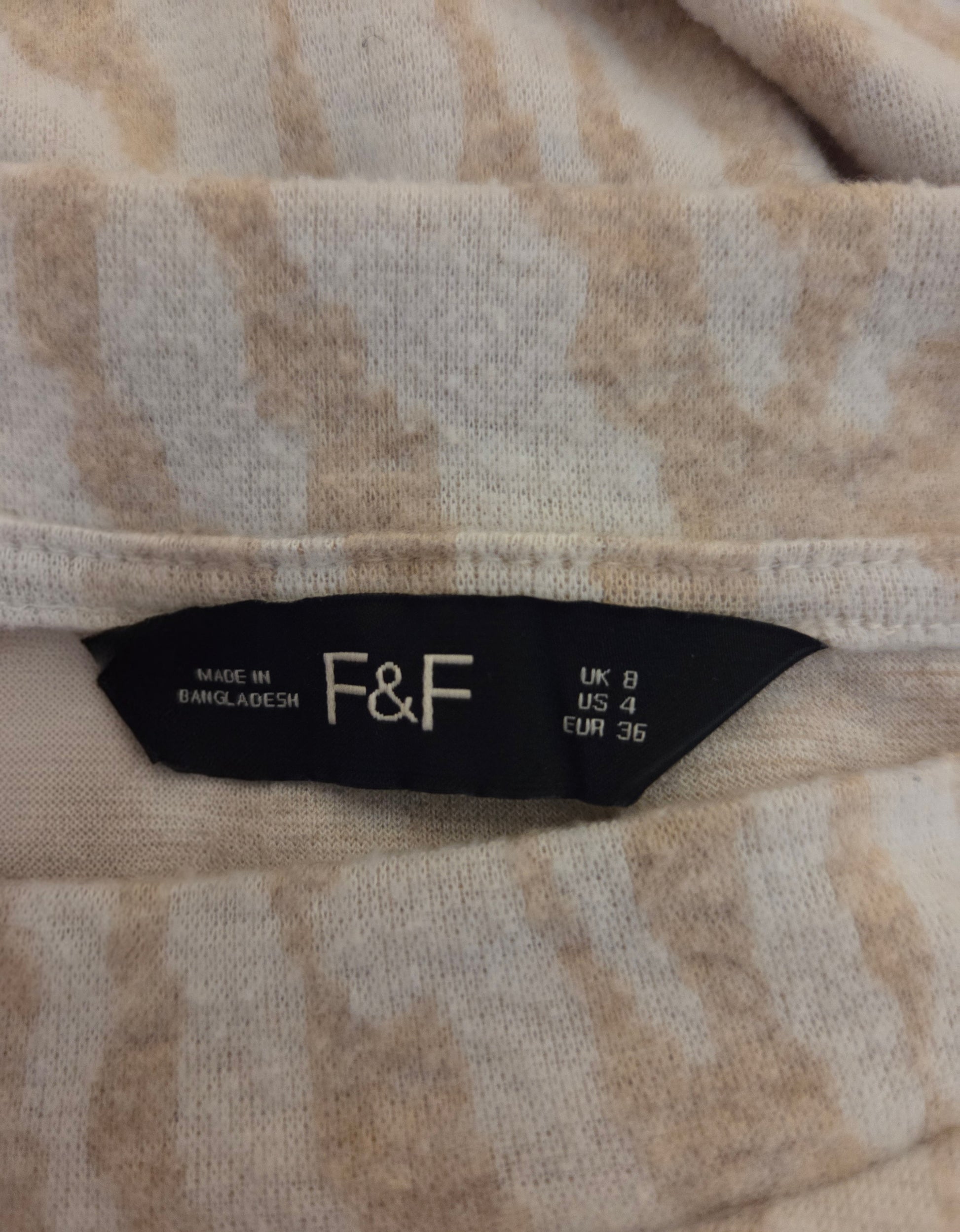 Close-up of a size label with 'F&F' 