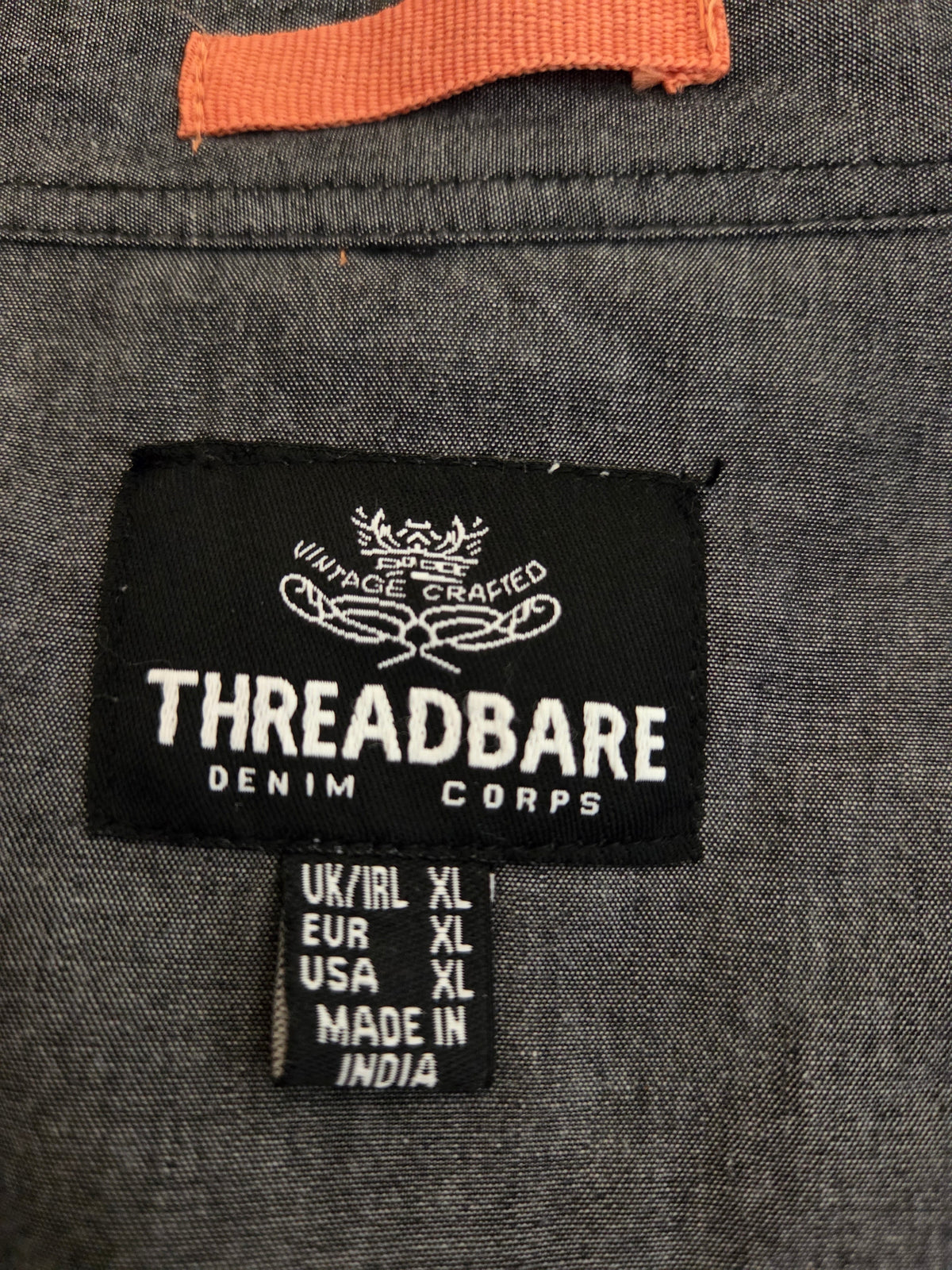 Close-up of shirt label showing Threadbare brand and size XL