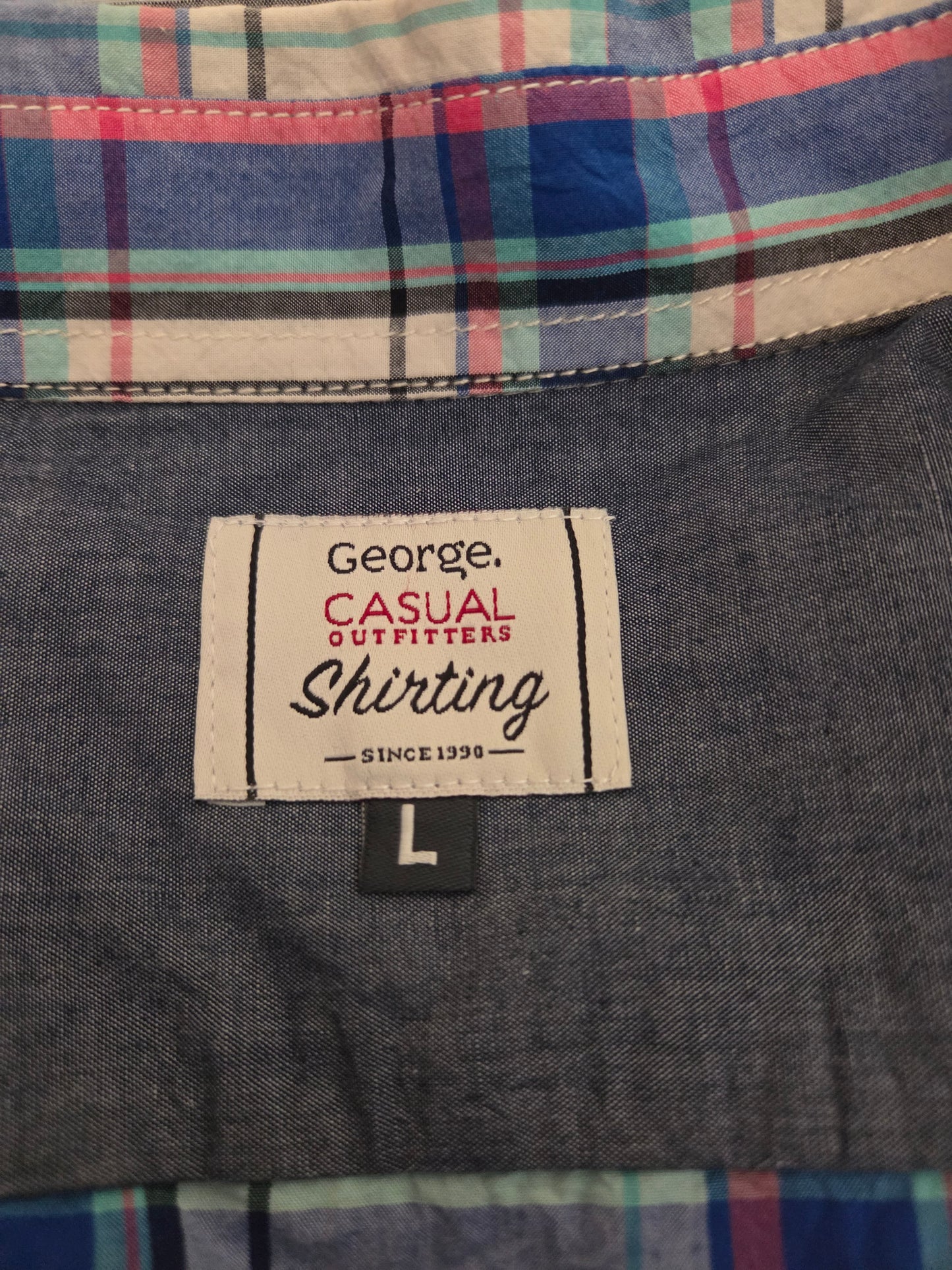 Close-up of plaid shirt fabric with multicolor check pattern and label