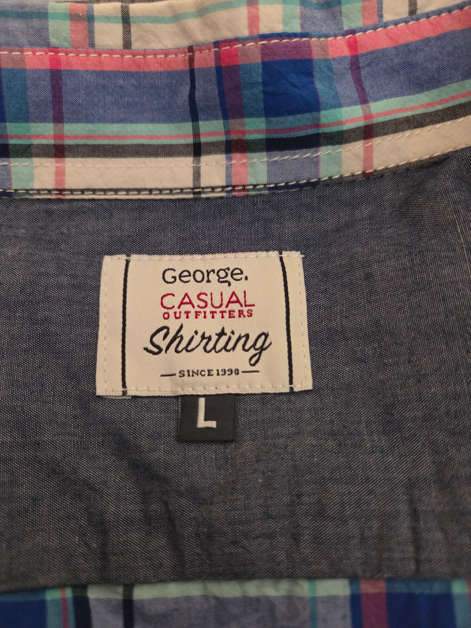 Close-up of plaid shirt fabric with multicolor check pattern and label