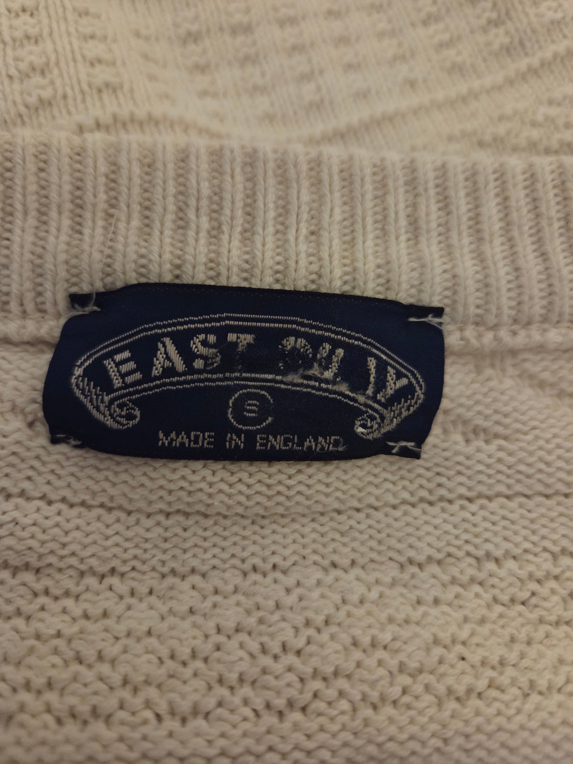Size label on a beige jumper