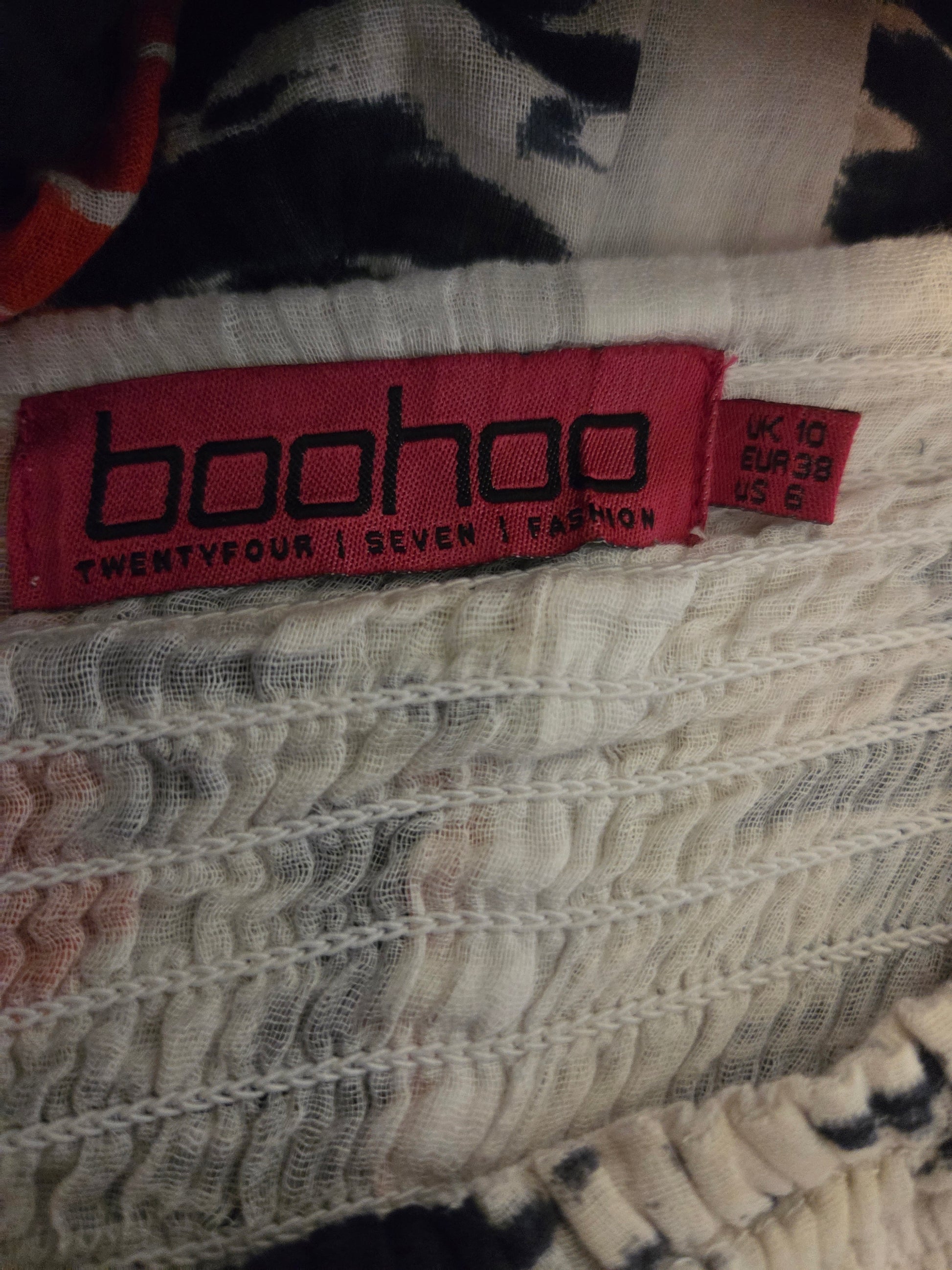 Boohoo label on a garment with a patterned background