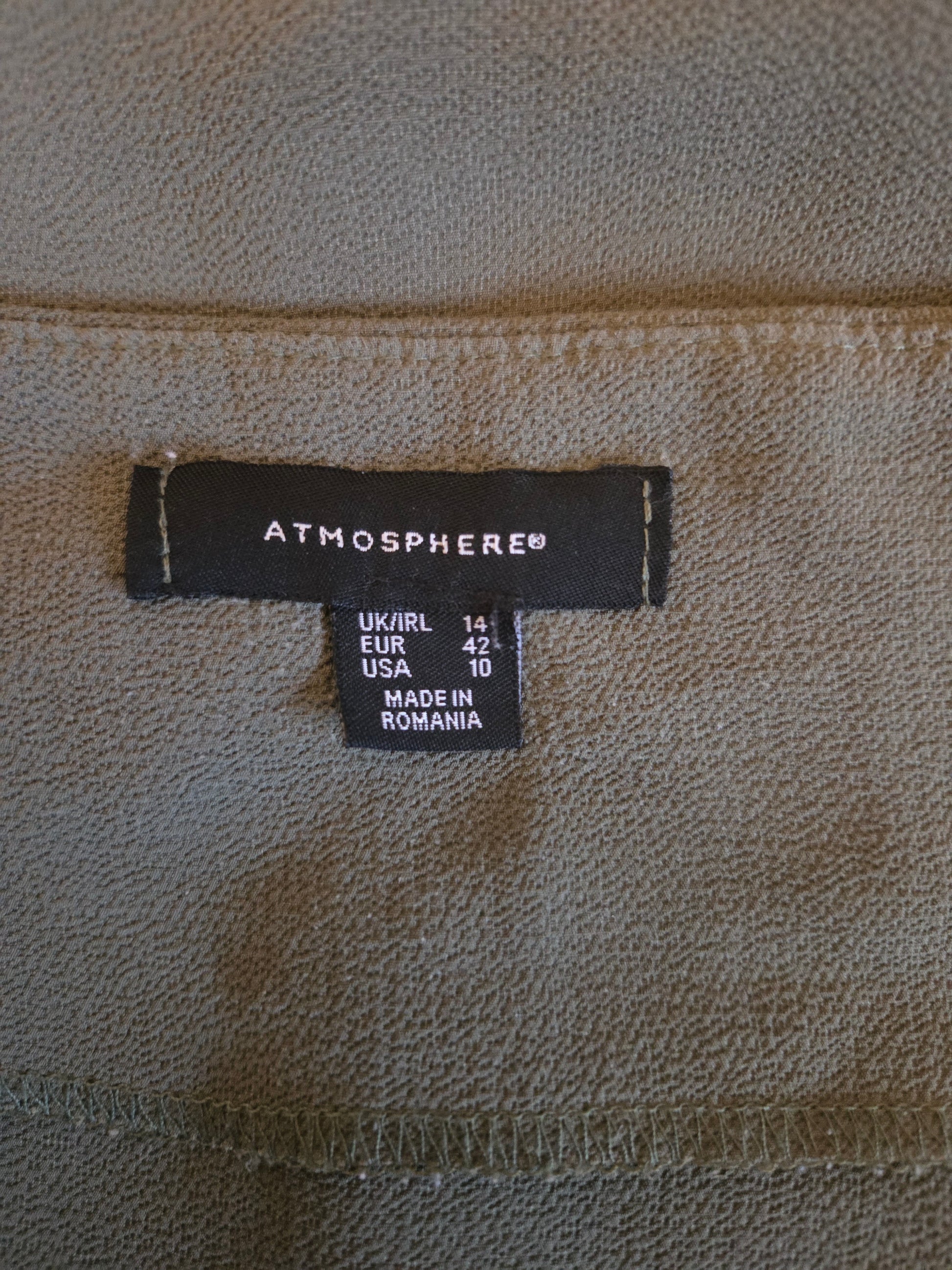 Size label on a textured fabric background
