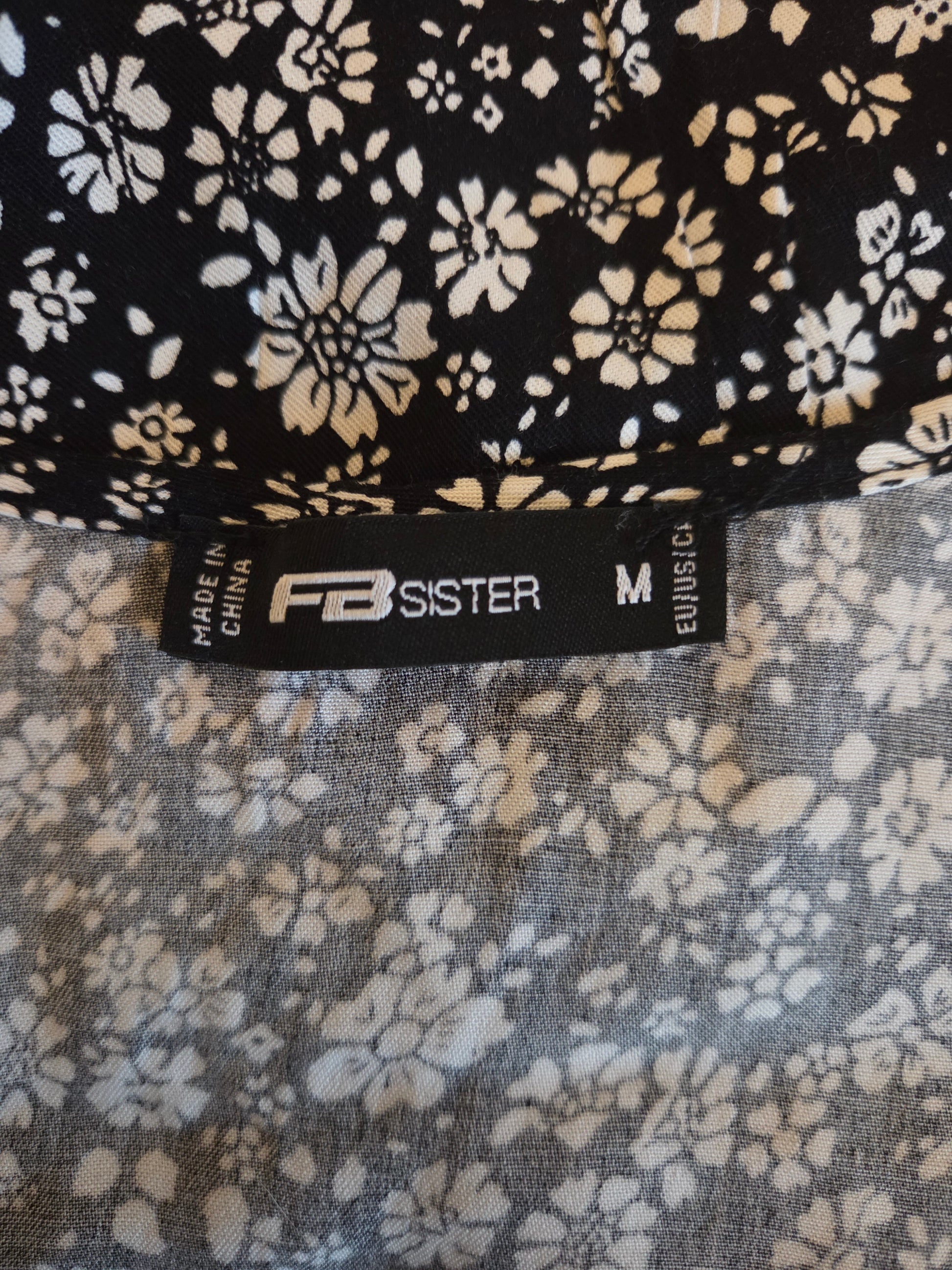 Floral patterned fabric with 'FB Sister' label