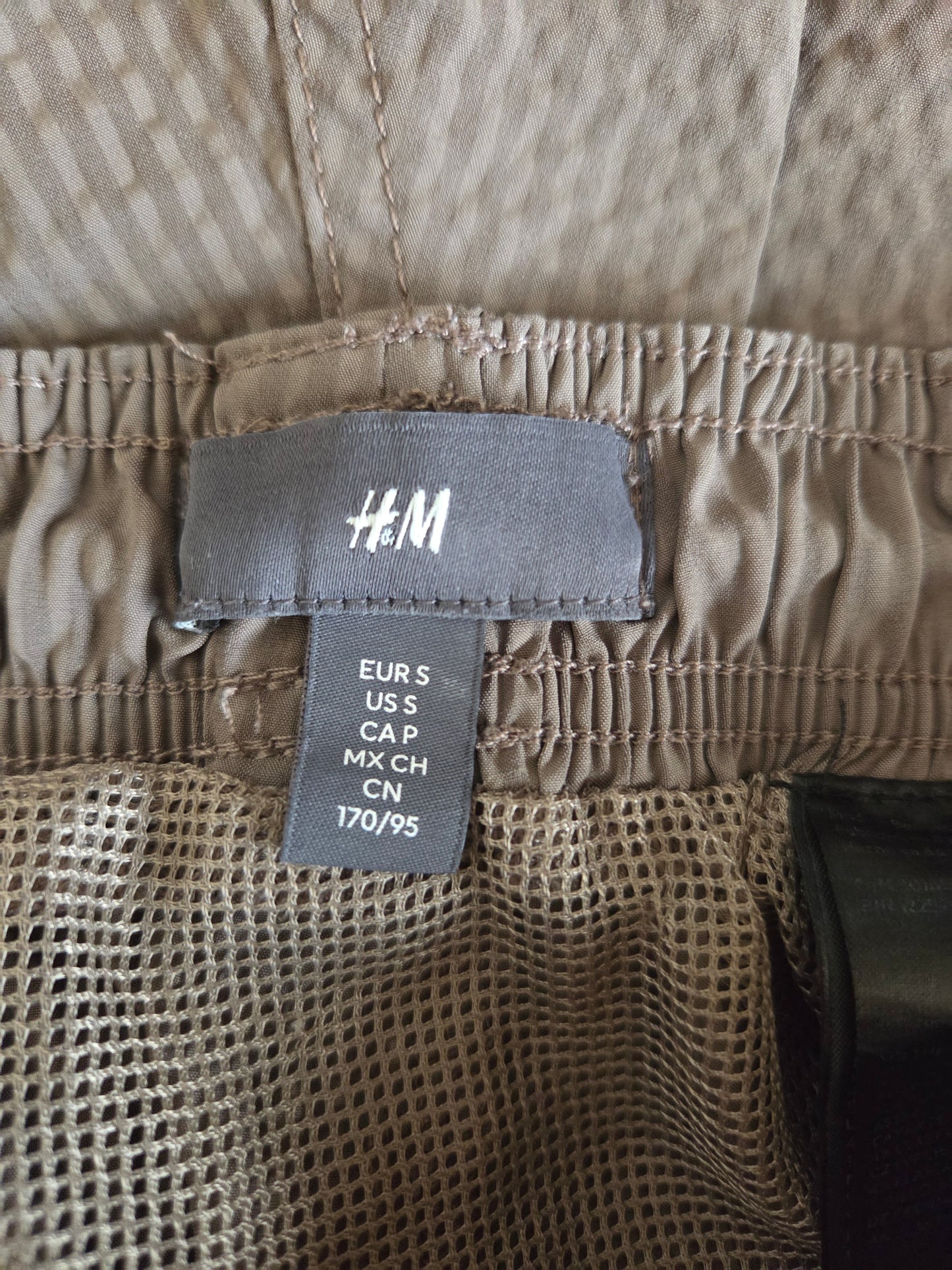 Close-up of a size label 'H&M' branding.
