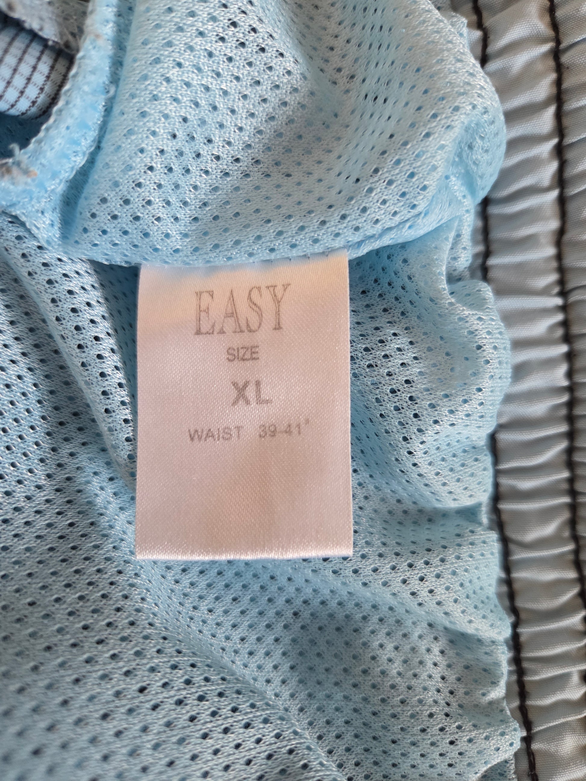 Light blue textured fabric with a size label on top