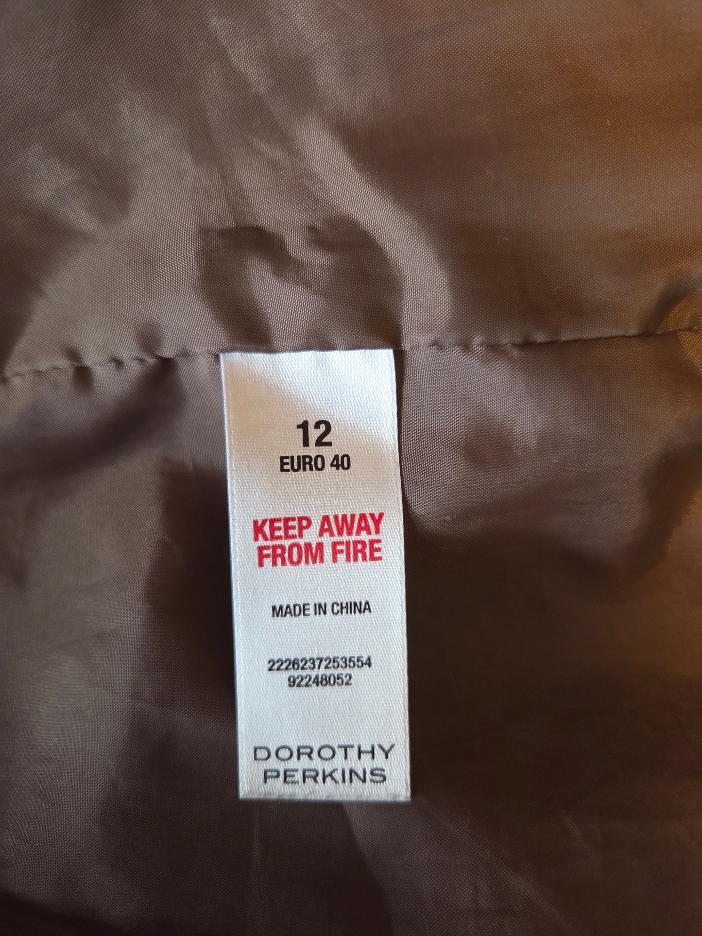 Label on a brown fabric with 'Dorothy Perkins' branding