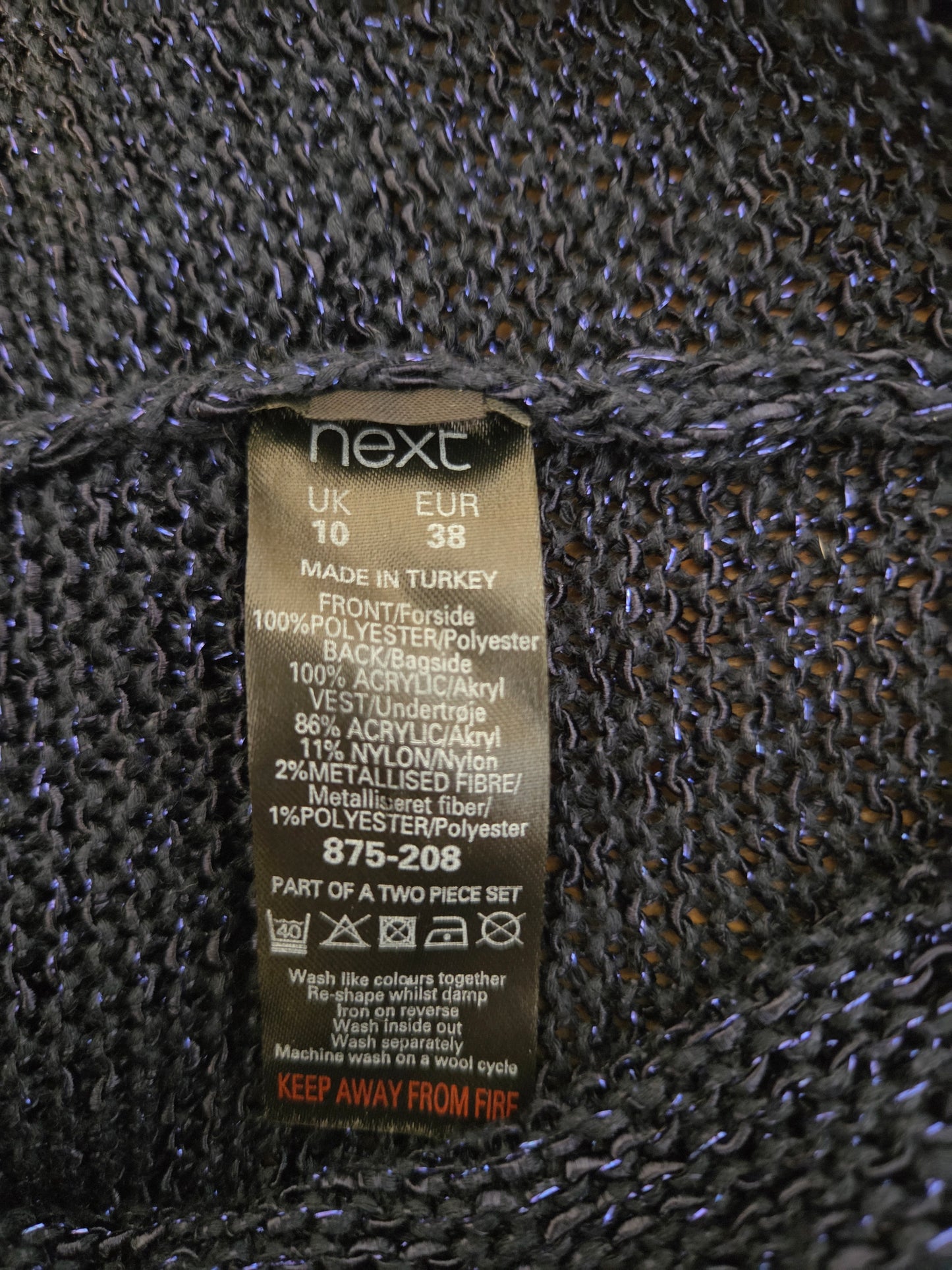 Clothing size label on a textured fabric background