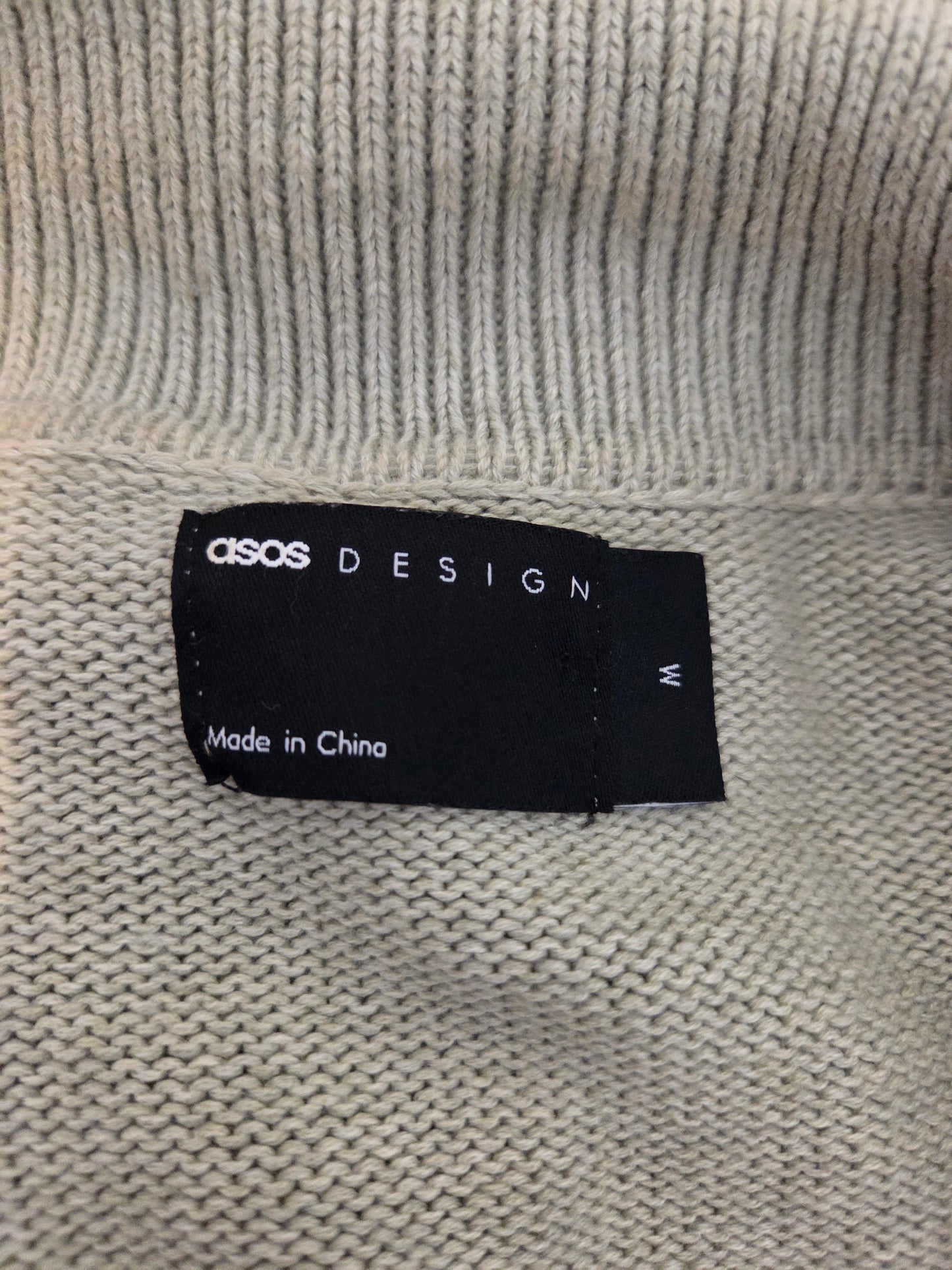 ASOS Design label on a textured fabric background