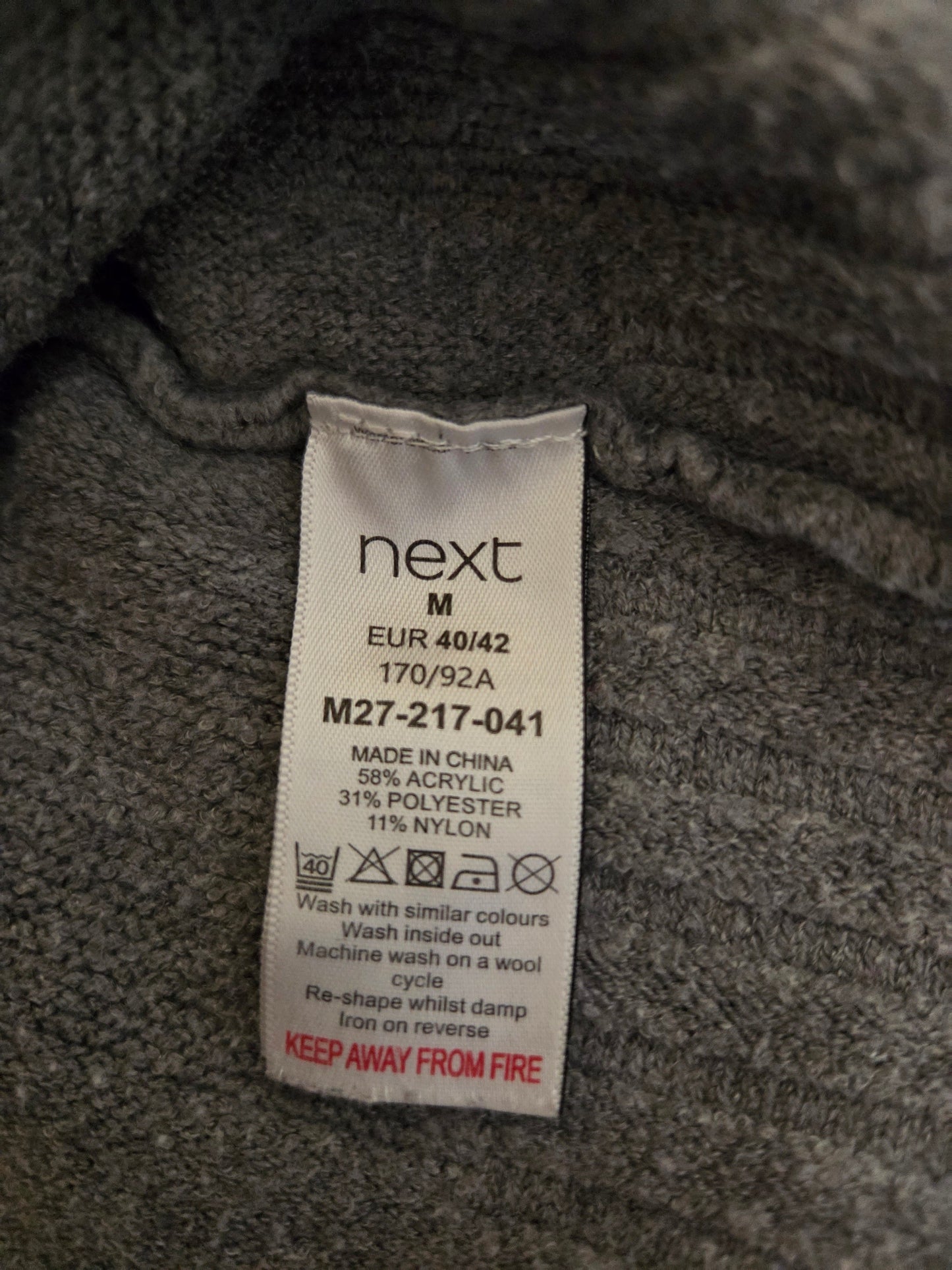 Next size label on a textured fabric background