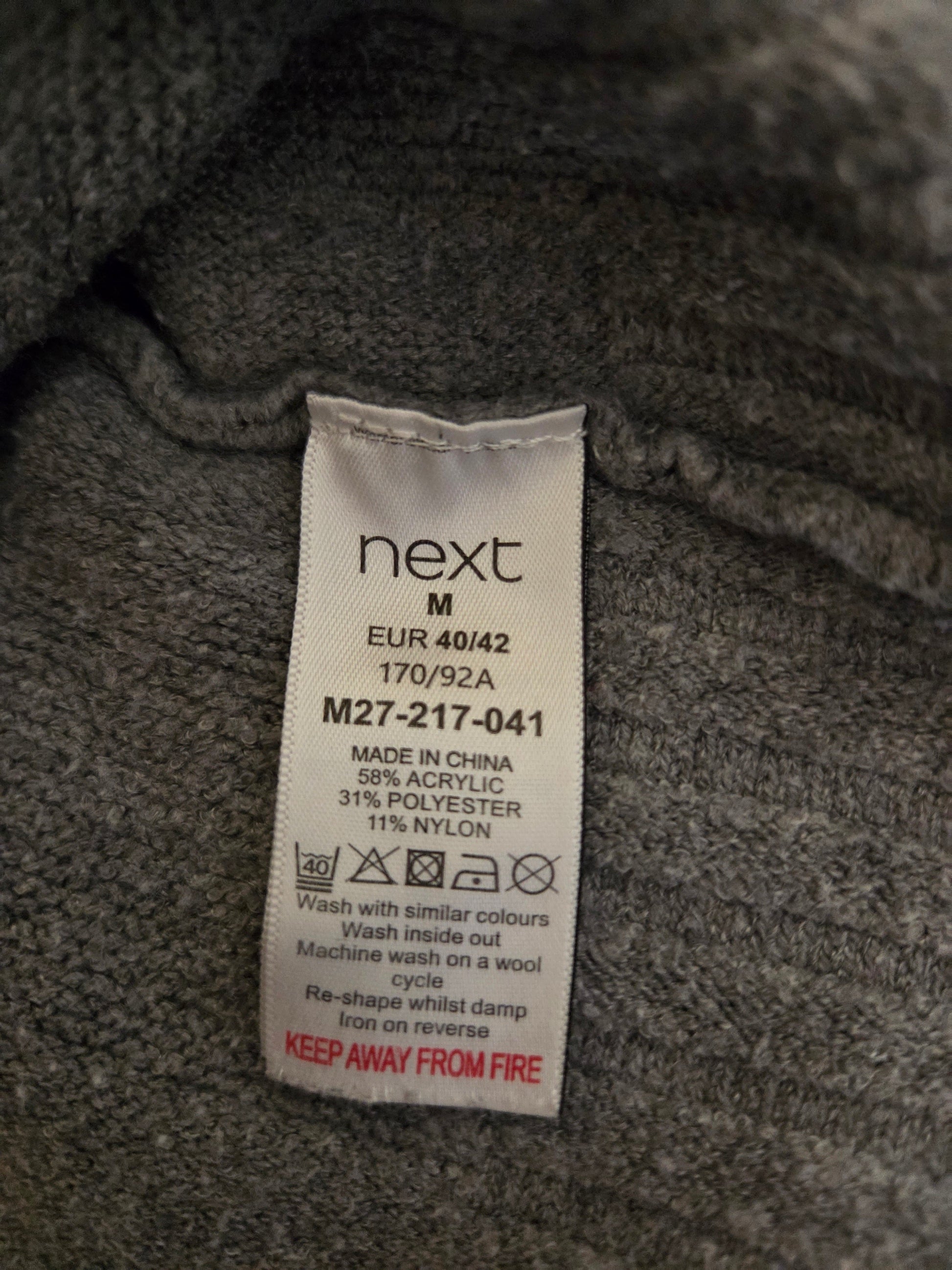 Next size label on a textured fabric background