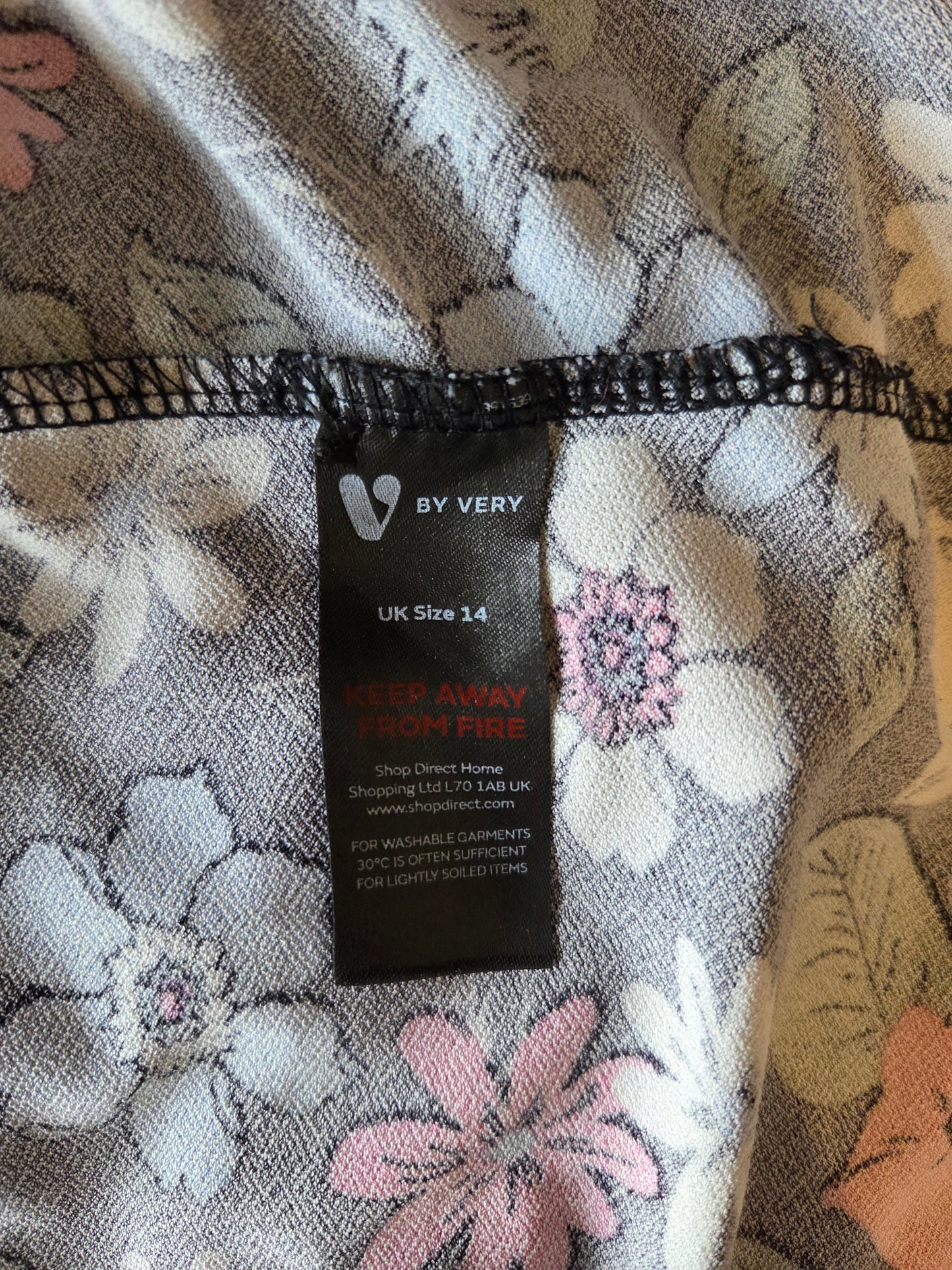 Clothing tag on a floral-patterned fabric
