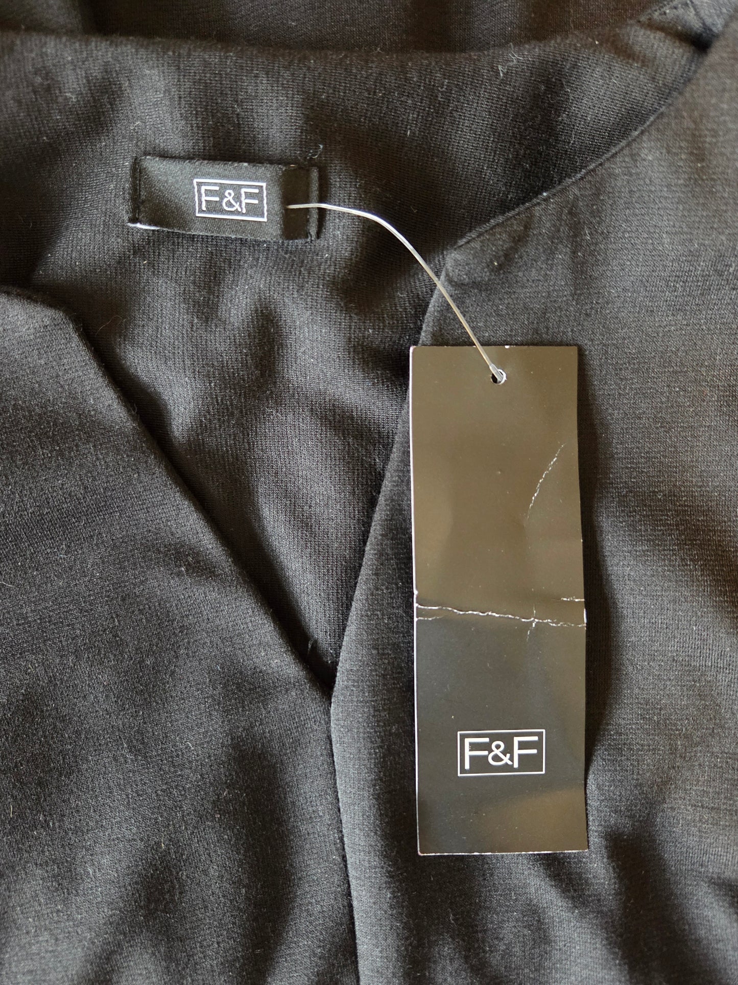 Black fabric with F&F label on a tag