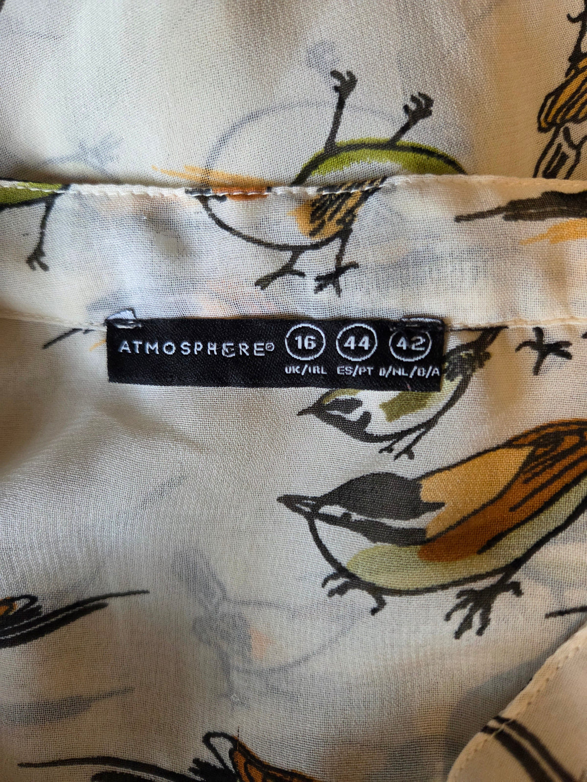 Close-up of size label with bird patterns 