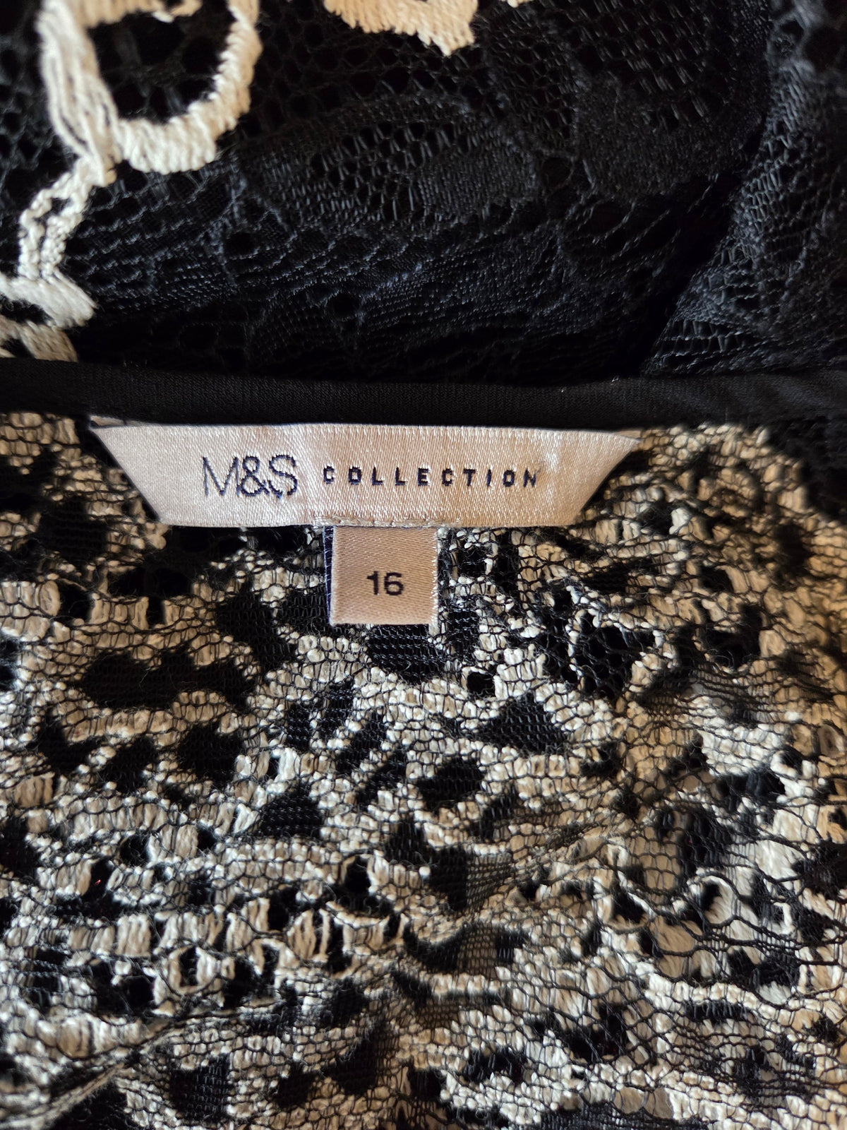 Close-up of a M&S Collection size label on a patterned garment.
