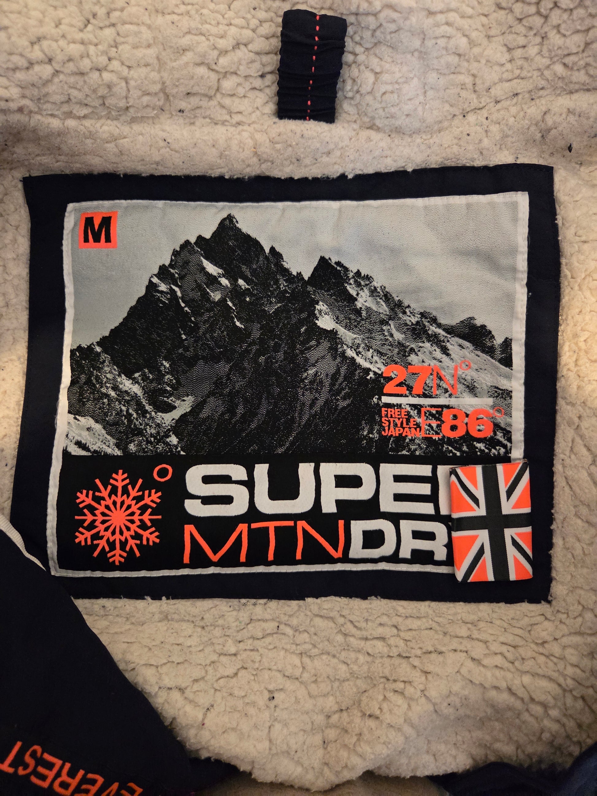 Label with mountain design and text on a textured fabric background