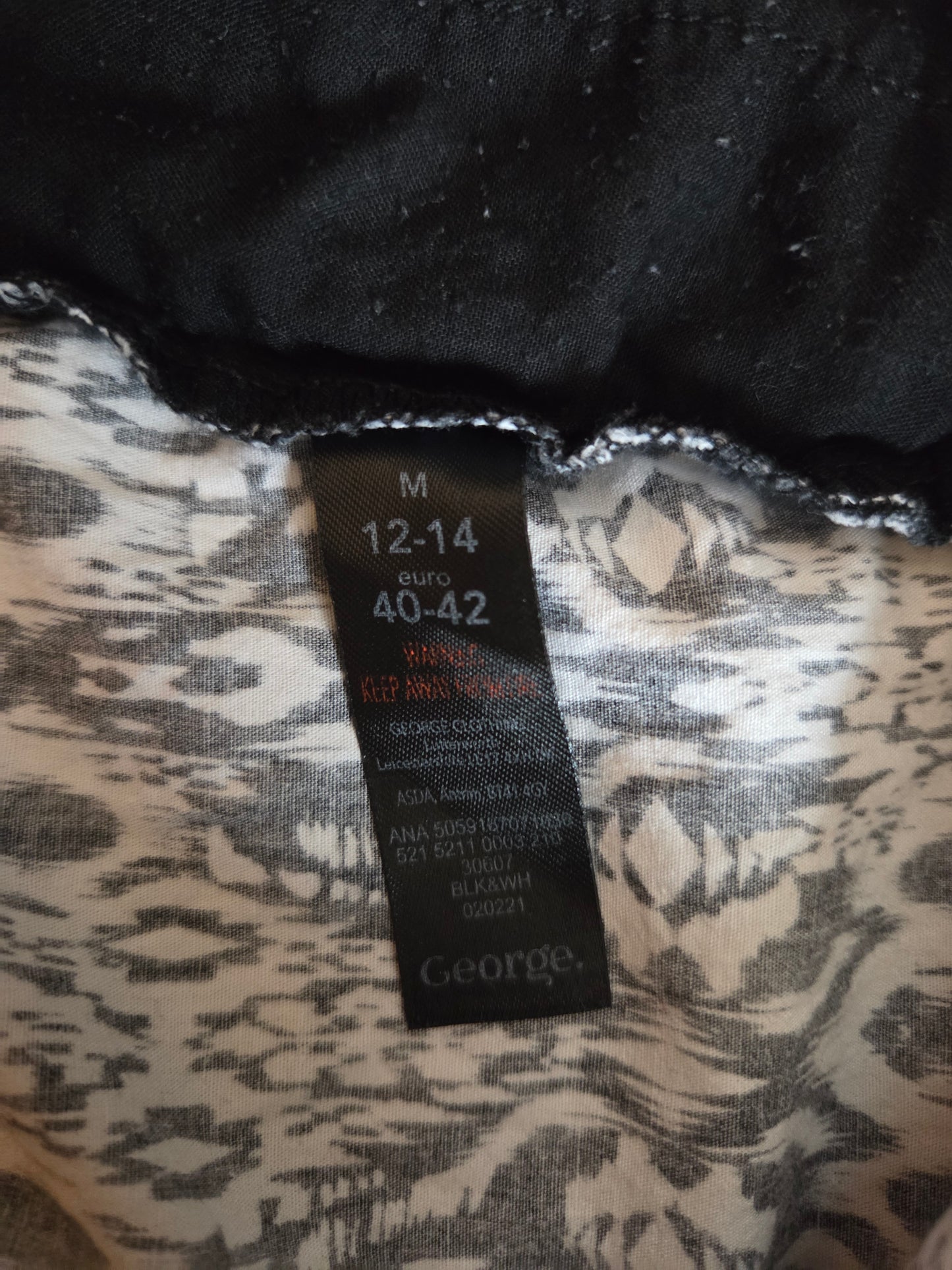 Size label on a patterned garment with brand name 'George'.