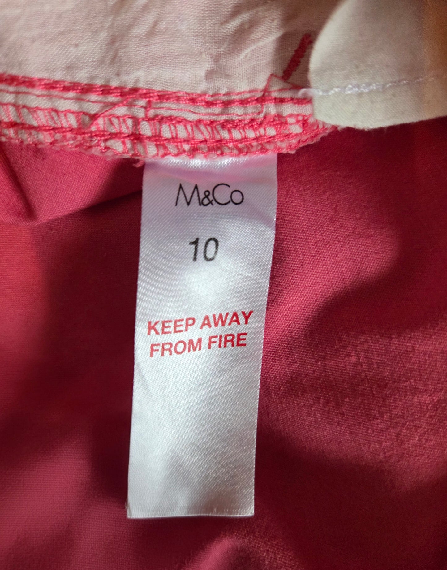 Close-up of a size label with 'M&Co' branding.