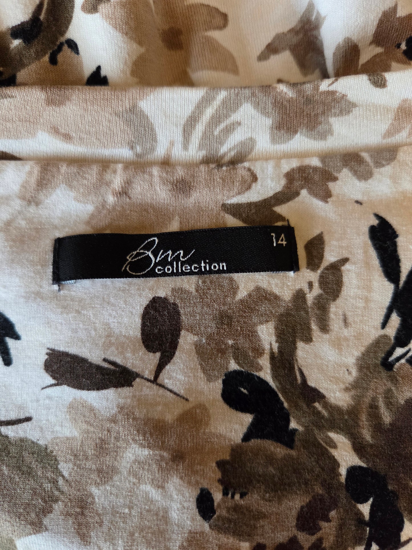 Floral patterned fabric with a brand label on a beige background