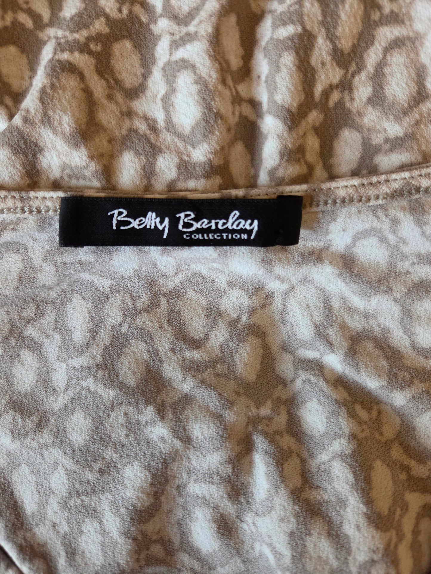 Close-up of a patterned fabric with a label reading 'Betty Barclay Collection'.